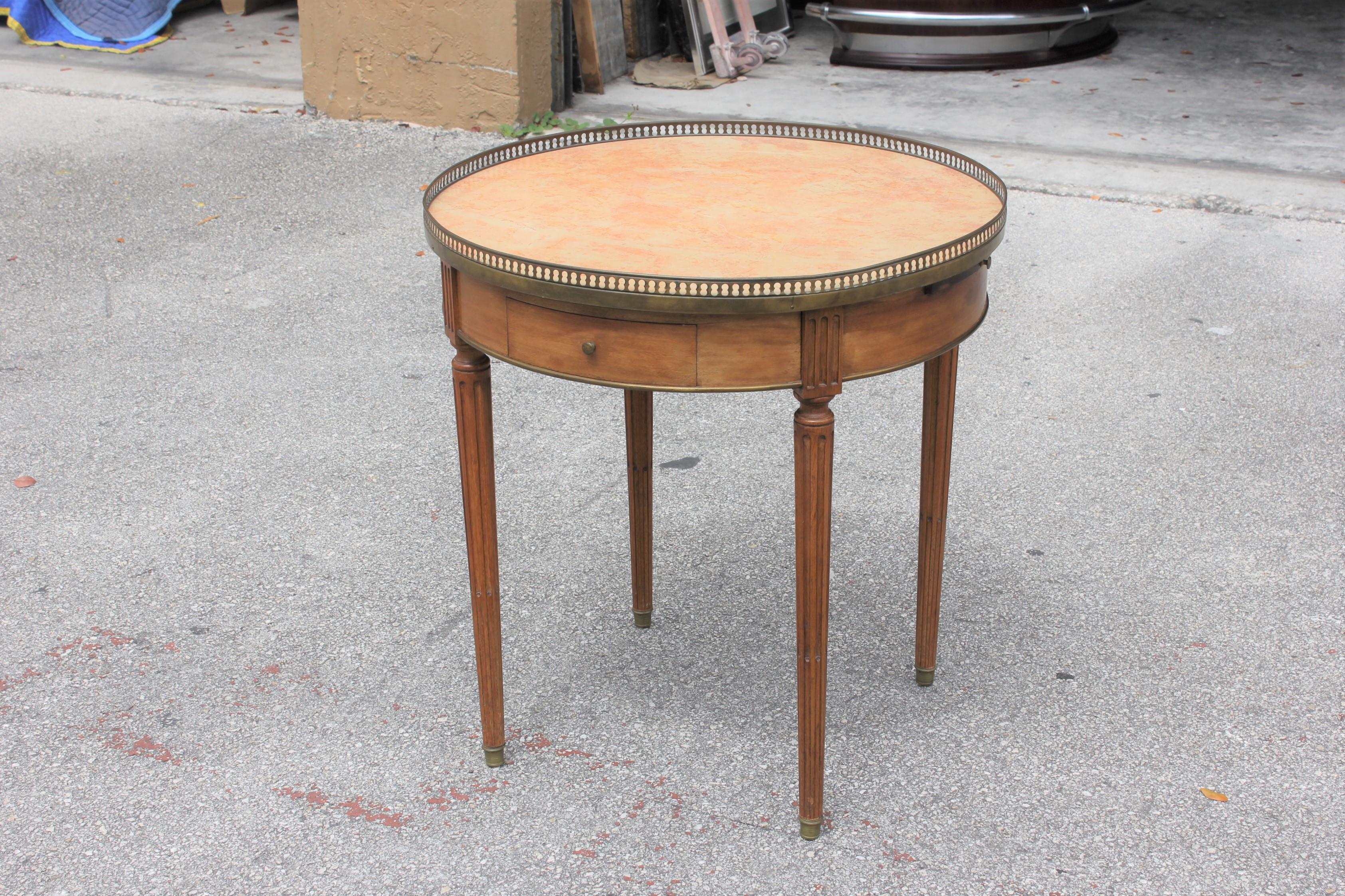 Beautiful French XVI bouillotte table solid mahogany, circa 1900s, this side table has two drawers and two pull-out tablet shaped leaves. Each leaf adds an additional 7” to the length, and are covered with a brown leather surface. The marble top is