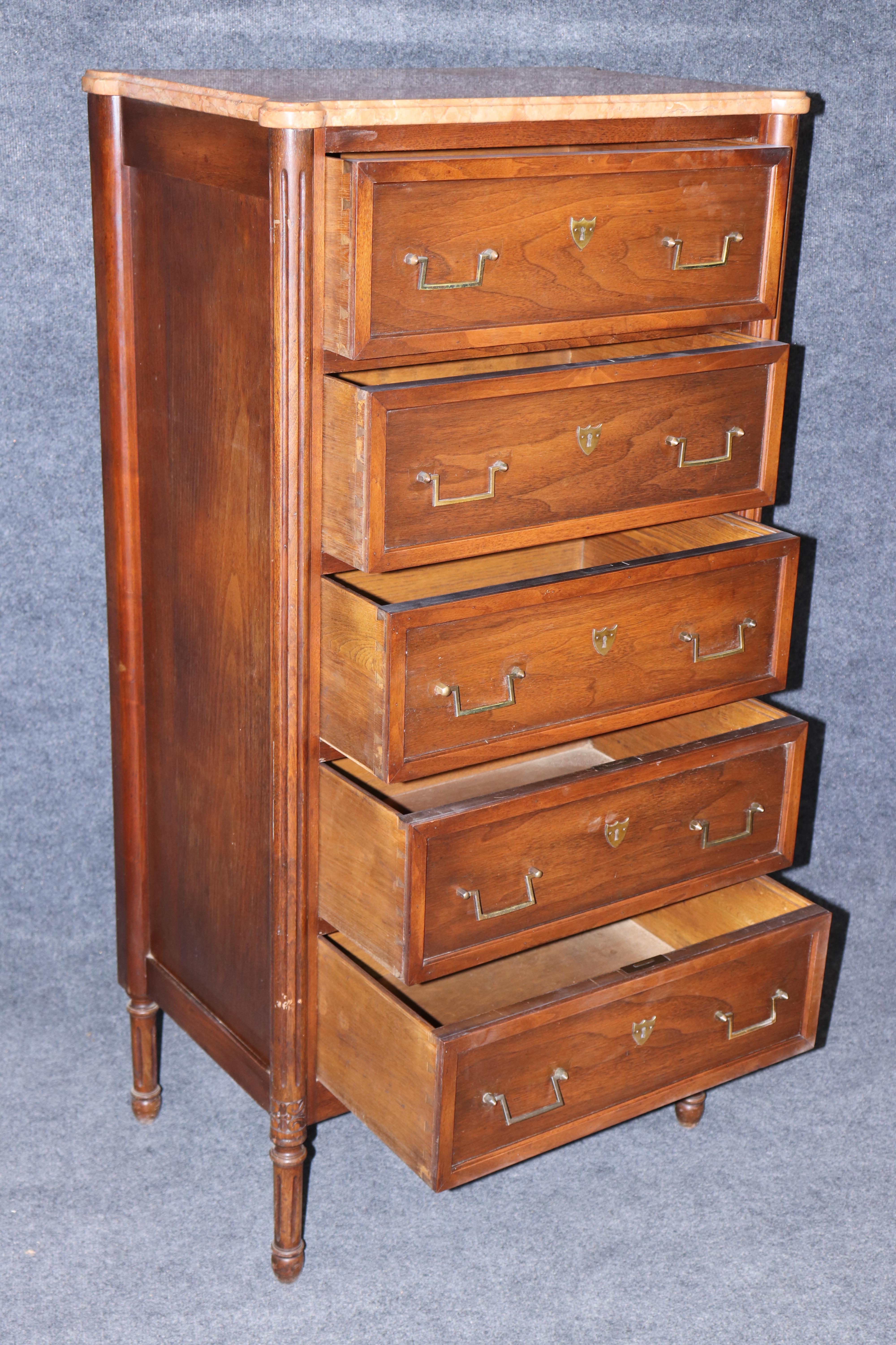 This is a beautifully made French 1920s era marble top Lingerie chest. The chest is in good antique condition with minor signs of age and use and has a beautiful marble top the is perfect for narrow spaces and dovetailed drawers for quality.
