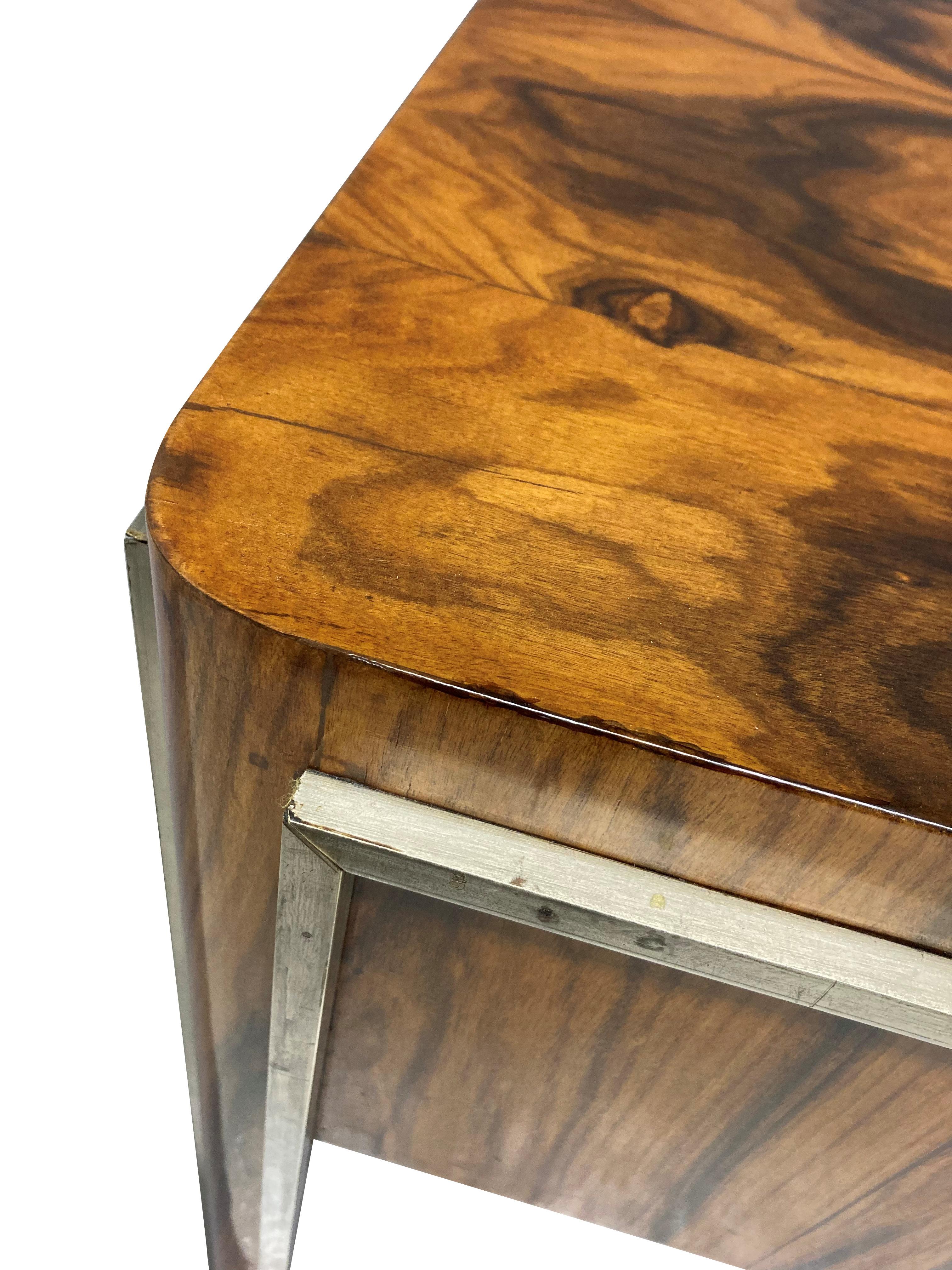 A fine French desk in macassar wood, with three central drawers and with chrome edging and handles.