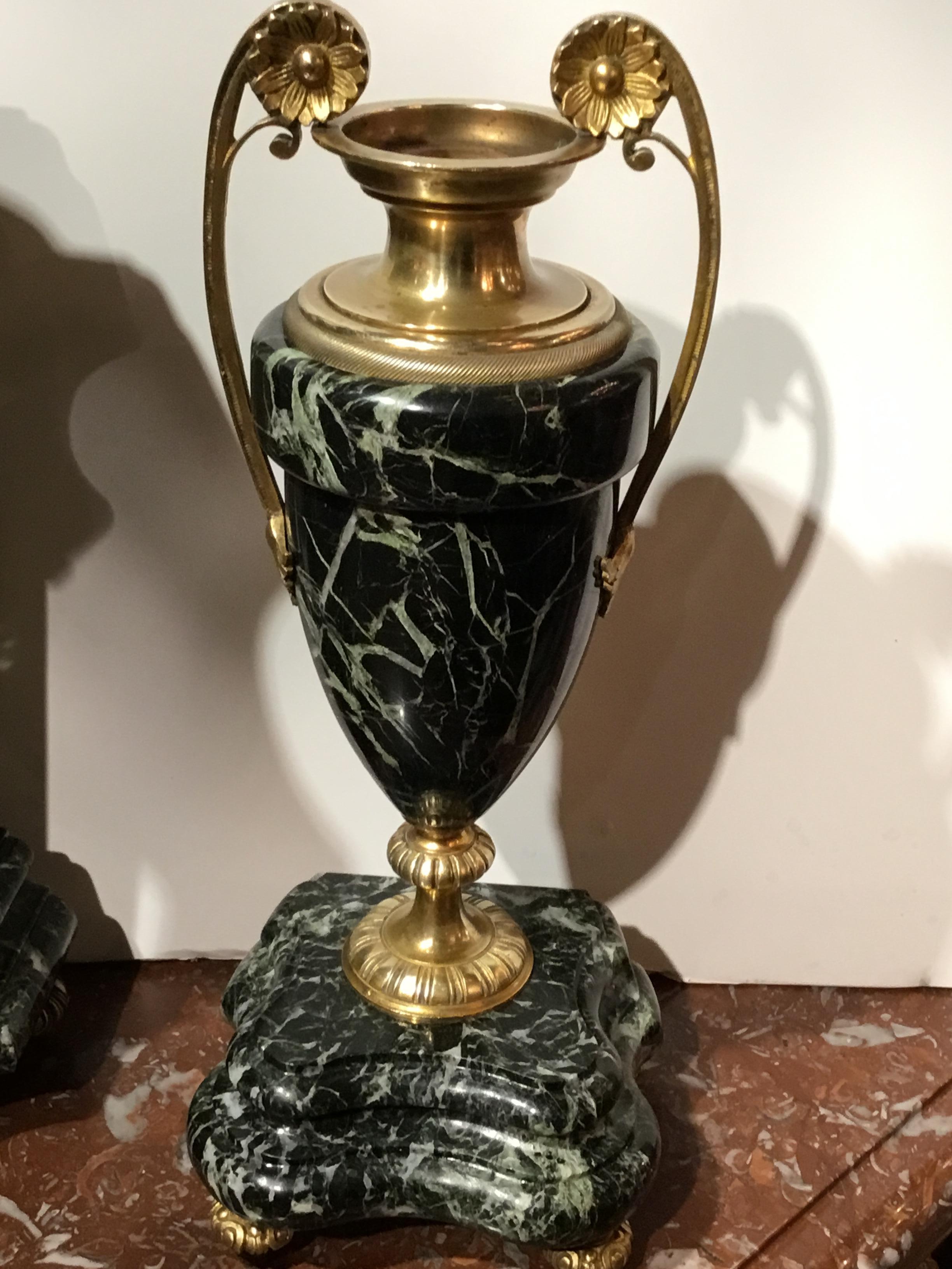 Deep Verde marble case with Corinthian columns adorn this fine clock, 19th century. Enamel face with
gilt bronze center decorate this clock. Bronze lion sits handsomely above the case.
Works signed A.D. Mougin.