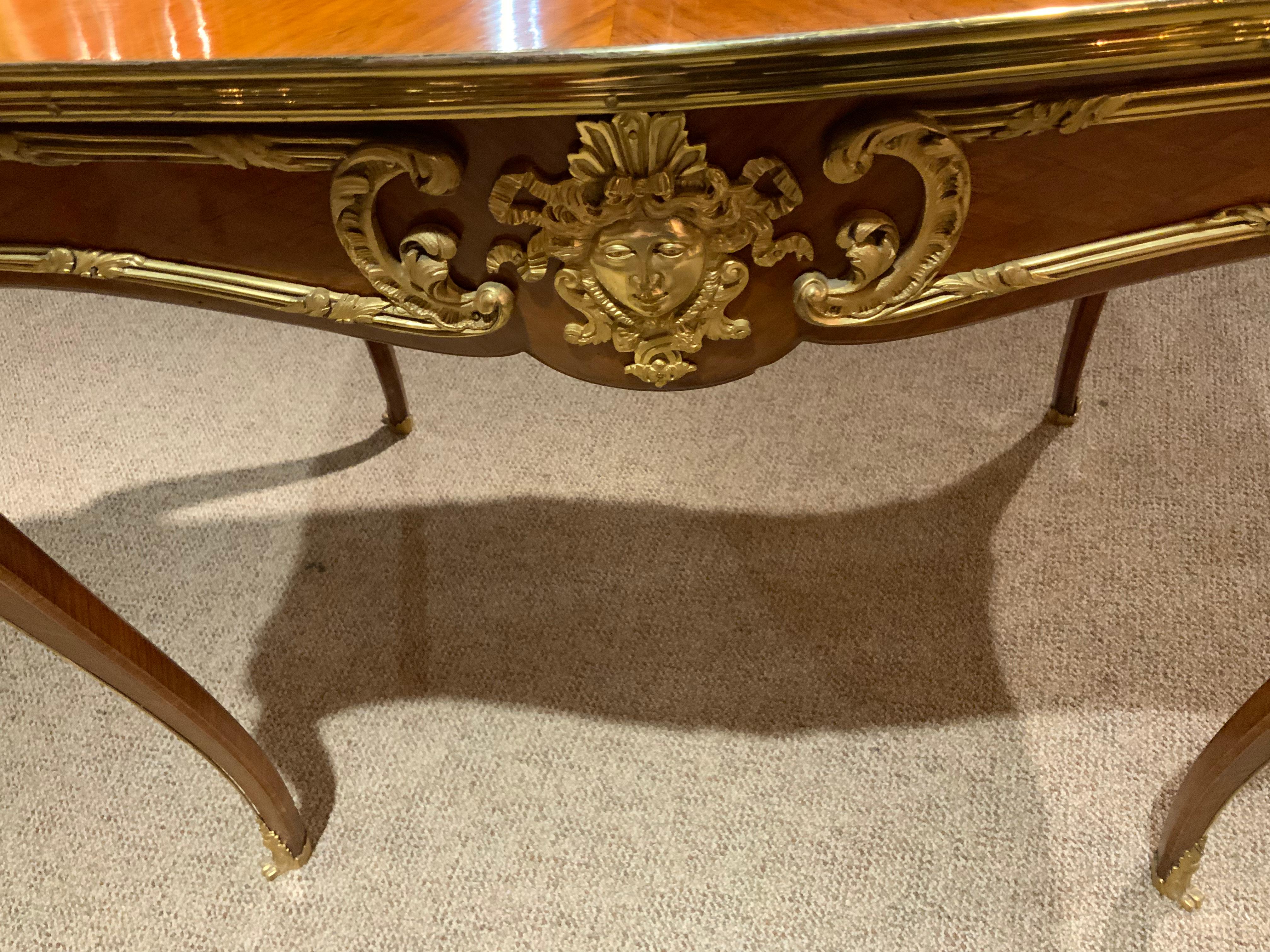 French side table with gilt bronze mounts having a single drawer. Figural mounts on each leg
And a gilt bronze mask on each side.