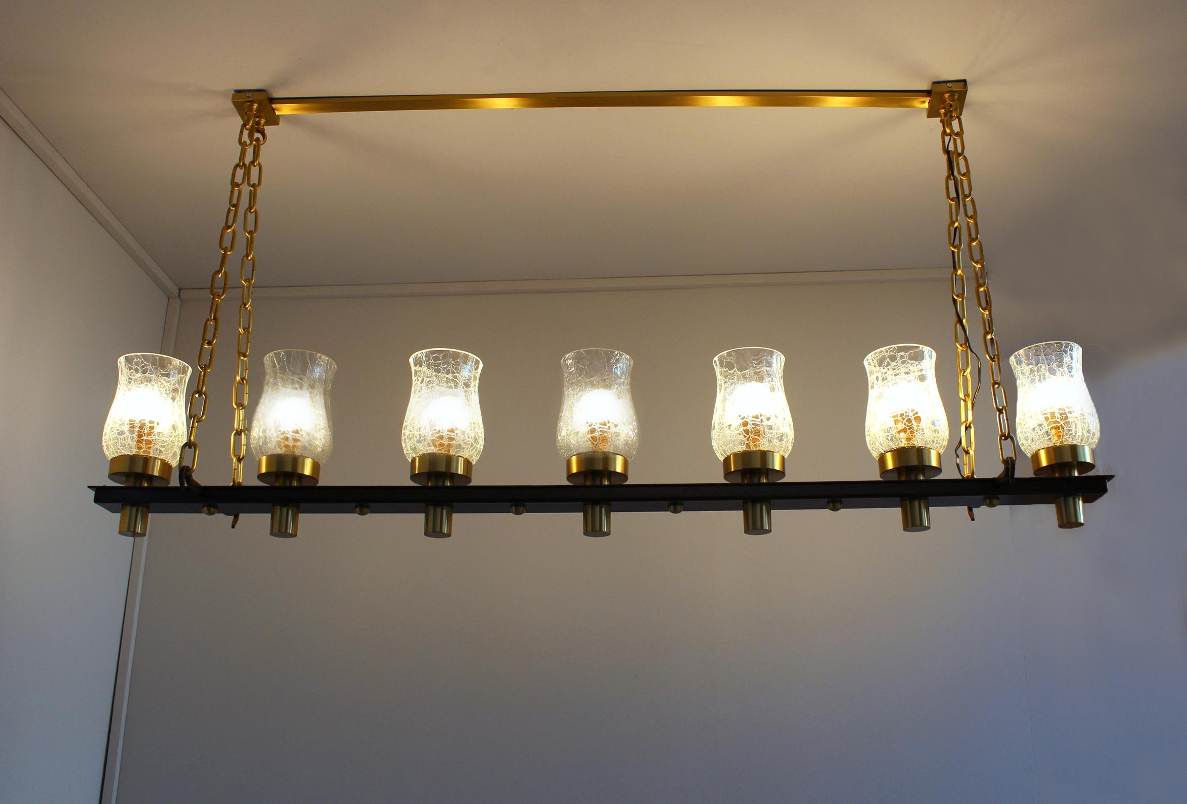 Jean Perzel - A fine French midcentury linear pendant with a brass and metal frame that holds seven crackled glass tulip shades.
