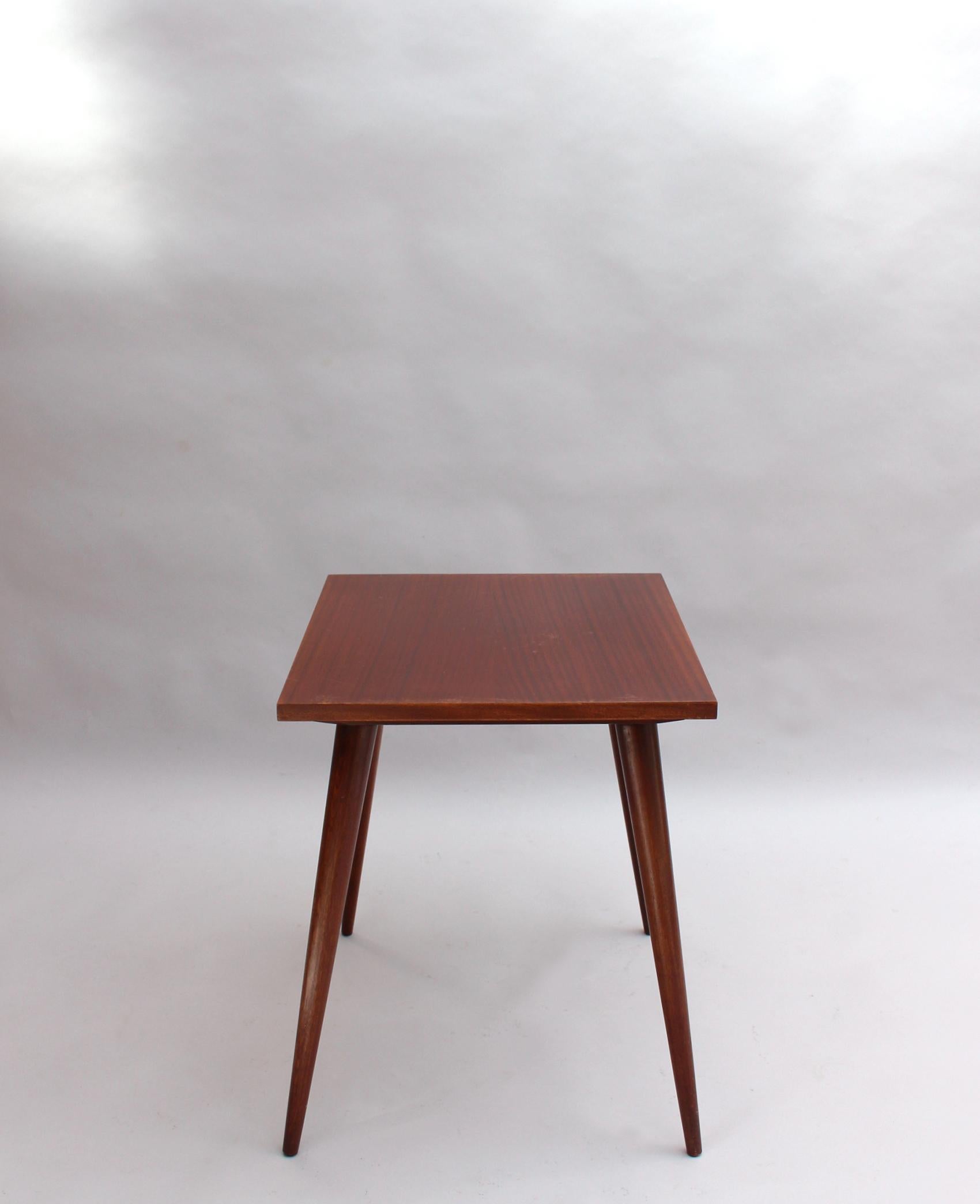 A fine French 1950s mahogany occasional table with a 4 compass leg base and a rectangular top.