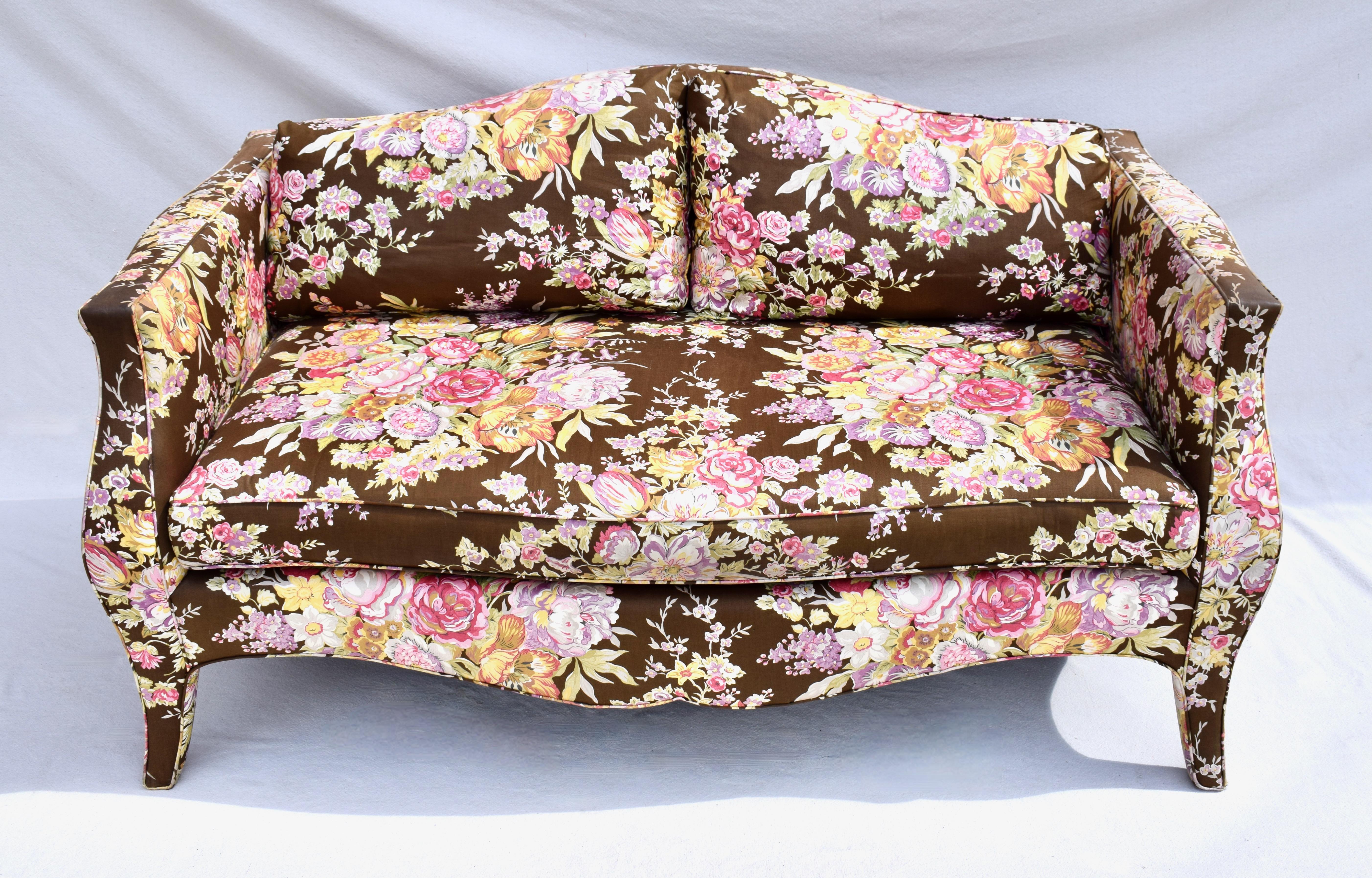 fine and sensuously curvy vintage canapé of high quality hardwood frame and feather cushions reupholstered in the mid 2020s in striking Ralph Lauren Floral Chintz. This loveseat is identical to examples by noted designer, Richard Himmel.