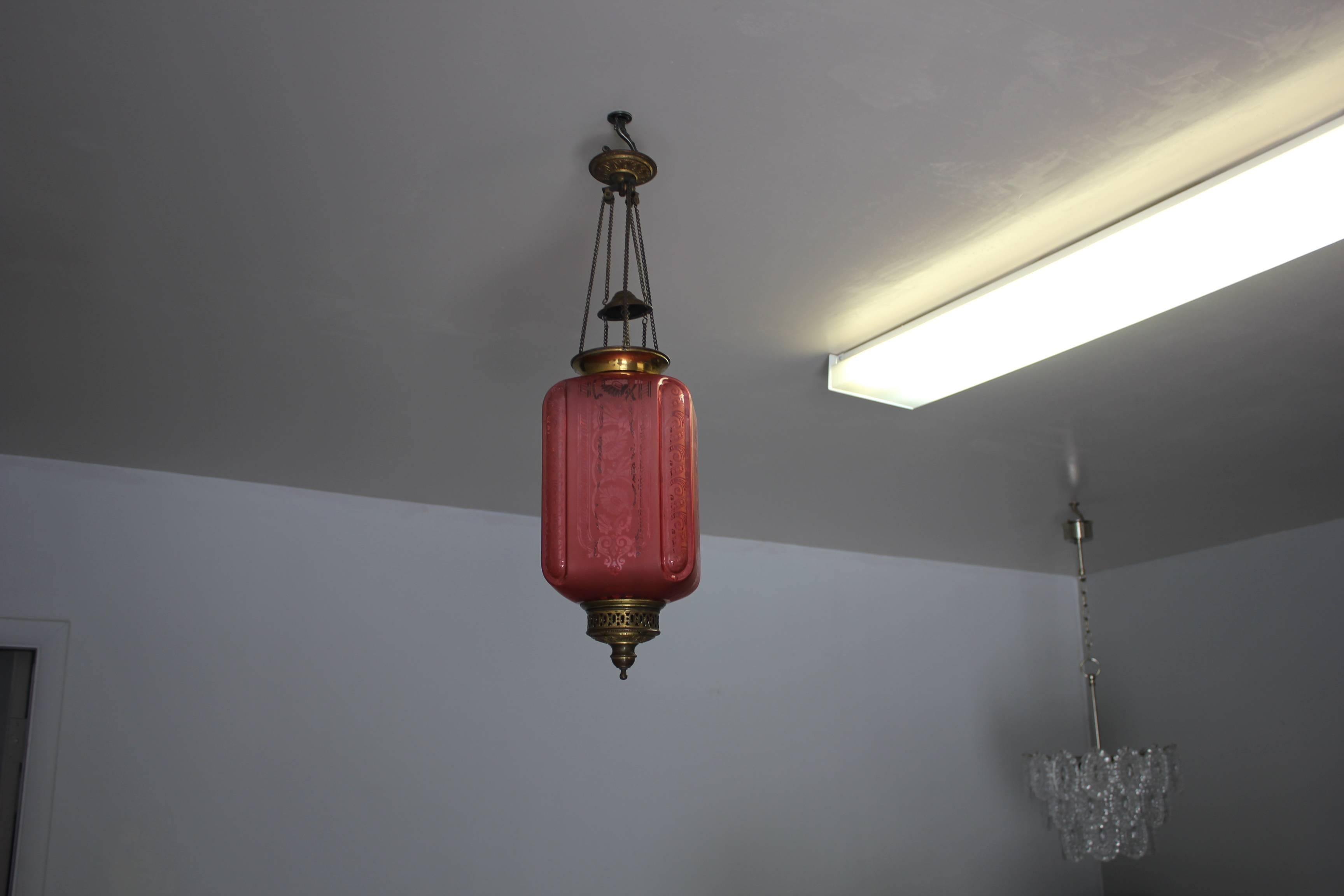 A unique pink color electrified oil lantern signed by Baccarat, 19th century, France. Beautiful design in the pink frosted glass. The lantern or the pendant are in perfect condition, no chips or cracks to the glass. Some oxidation to brass