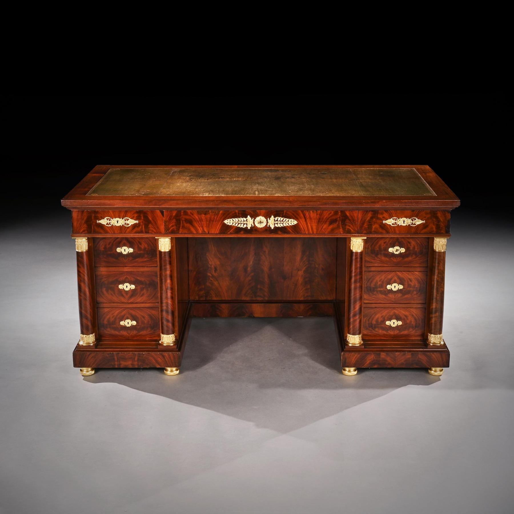 Fine French Napoleon III second Empire gilt bronze-mounted library desk probably by Krieger.



French Circa 1880.



Having finely constructed flame mahogany veneers over an oak carcass, the oblong leather lined top with recessed conforming