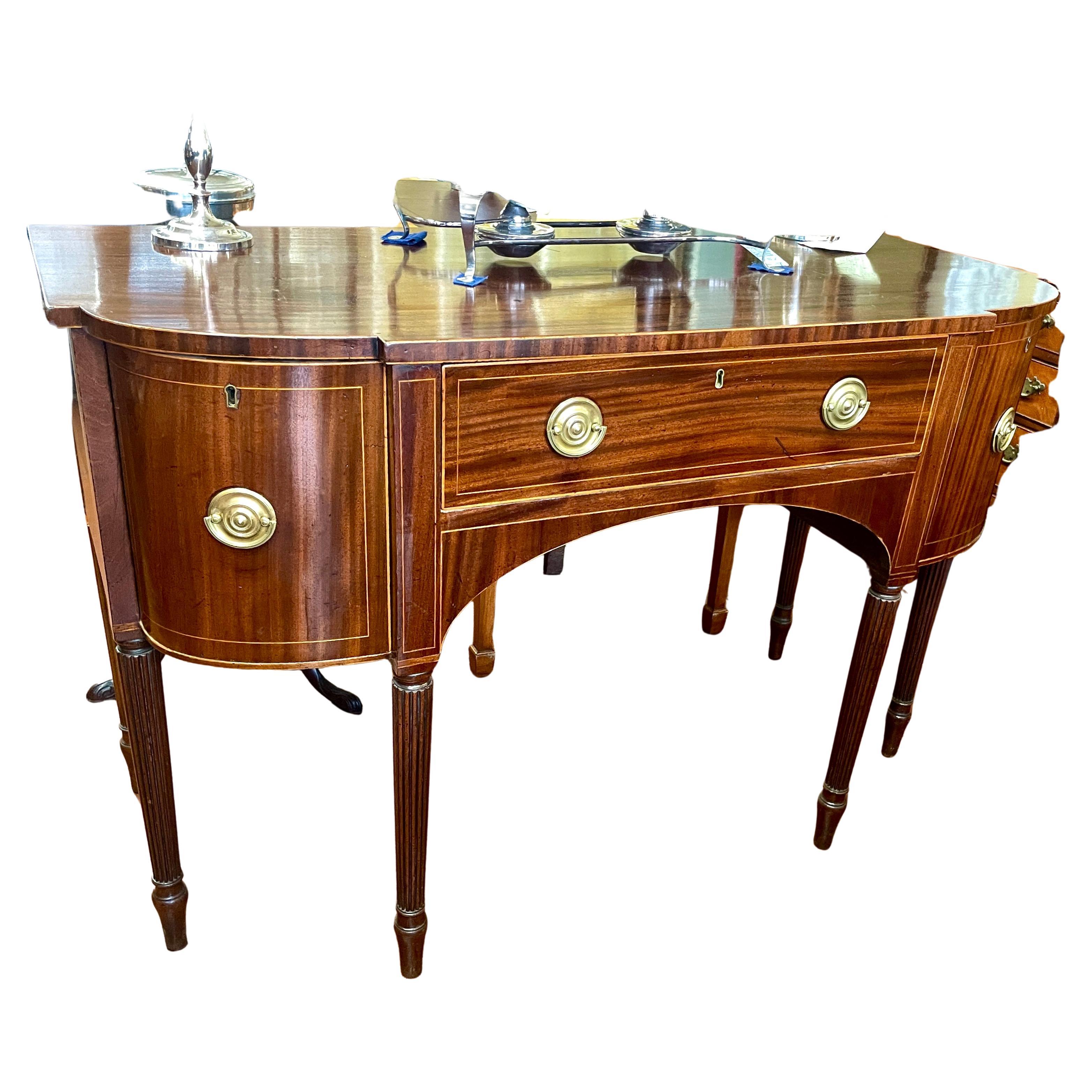 A very fine, delightful sized Antique English Geo. III figured mahogany Hepplewhite style sideboard with handsome boxwood line inlay, square tapered legs upon modified spade feet.  Side board has a large and deep cellarette drawer both left and