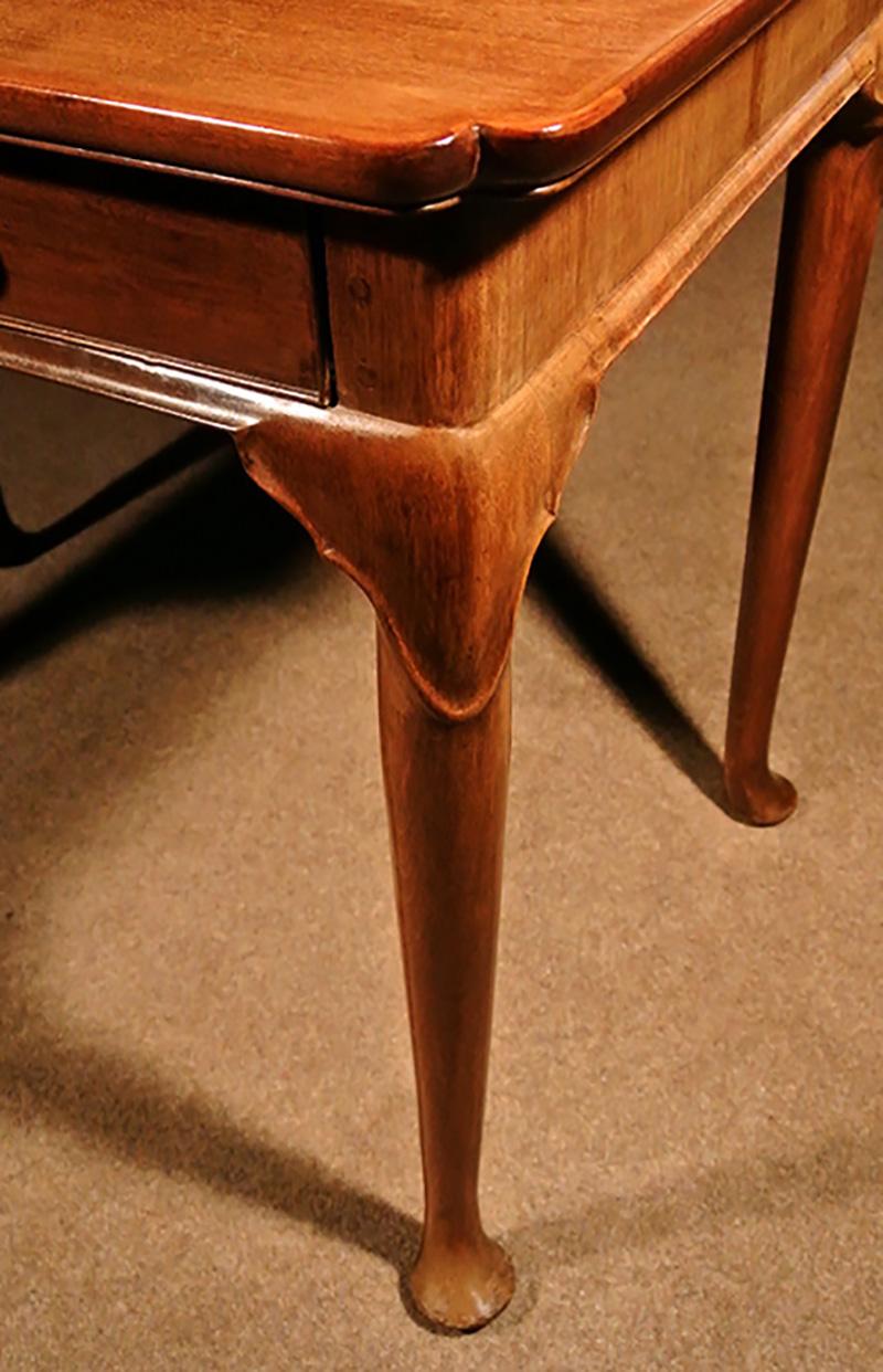 A fine quality George II silver table in solid mahogany and made in circa 1750.

The dished top with re-entrant corners over a deep cross-banded frieze with single original oak lined drawer. 

The drawer with iron lock which appears to be