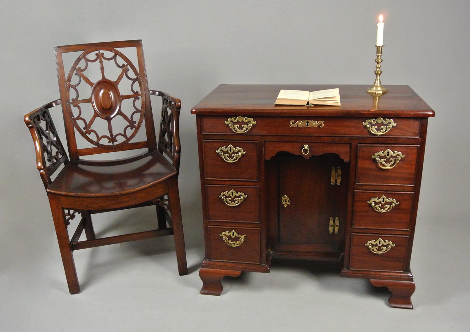 A particularly fine and handsome English George III desk of one long over two banks of three drawers and with a slender drawer above the kneehole.   All made in solid red walnut with a well developed and beautiful colour and deep natural