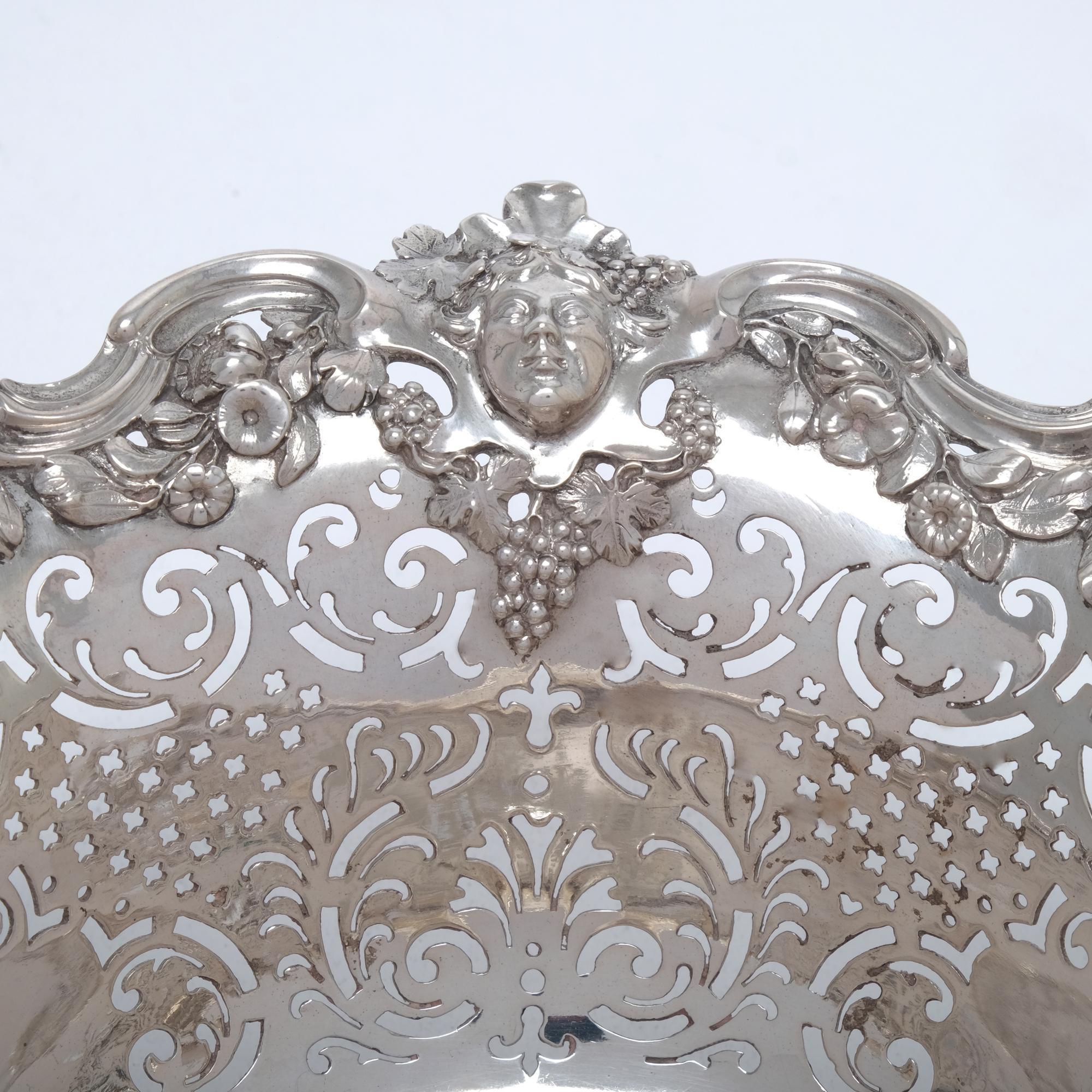 An absolutely wonderful example of the classic George II period (1727-1760) fruit basket with its finely detailed cast and applied mounts and hand-pierced sides illustrating all the elements that were popular at that time. The beautifully moulded