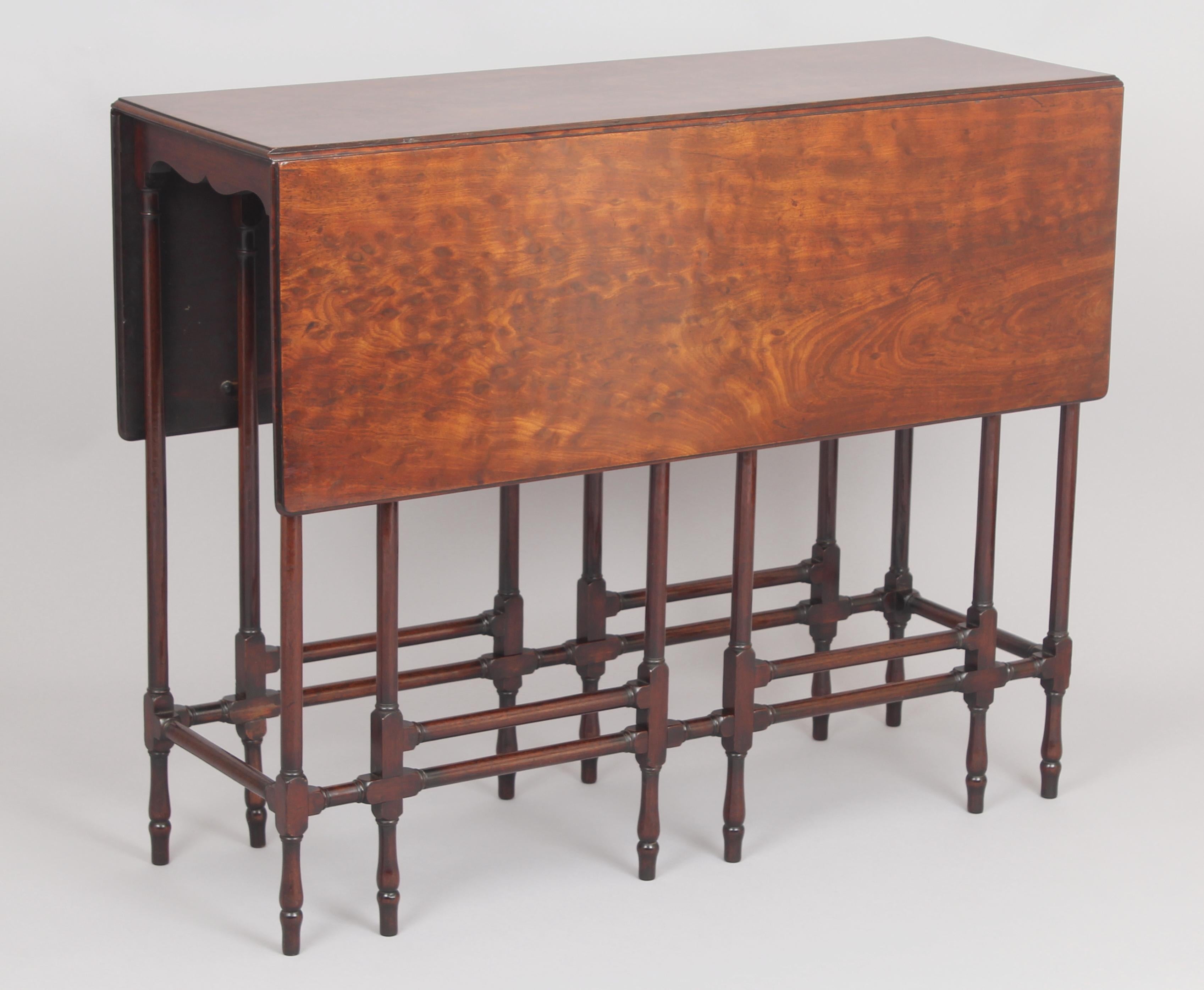 Fine George III period mahogany spider-leg drop-leaf table; the well-figured and patinated top on a double gate frame with slender turned rails.