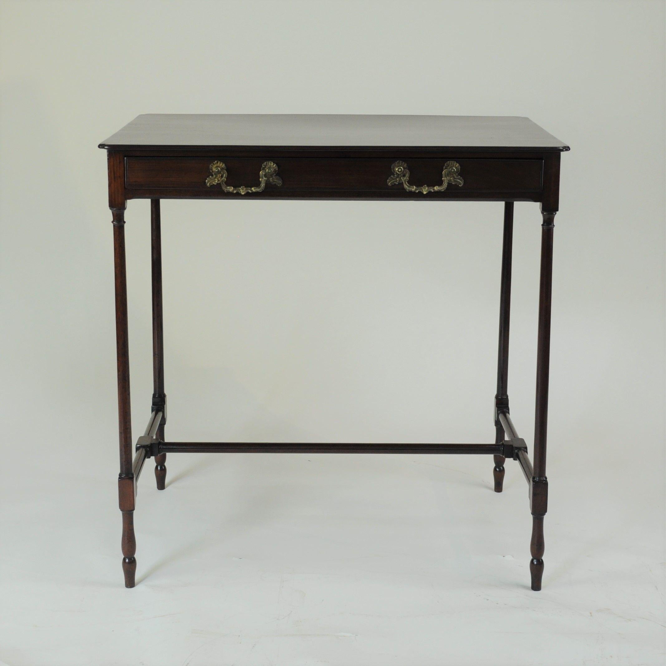 A fine quality 18th century mahogany 'spider legged' side table. The thin, one-piece top with re-entrant corners all round, above an apron fitted with an oak-lined narrow drawer and standing on extremely elegant slender turned legs, united towards