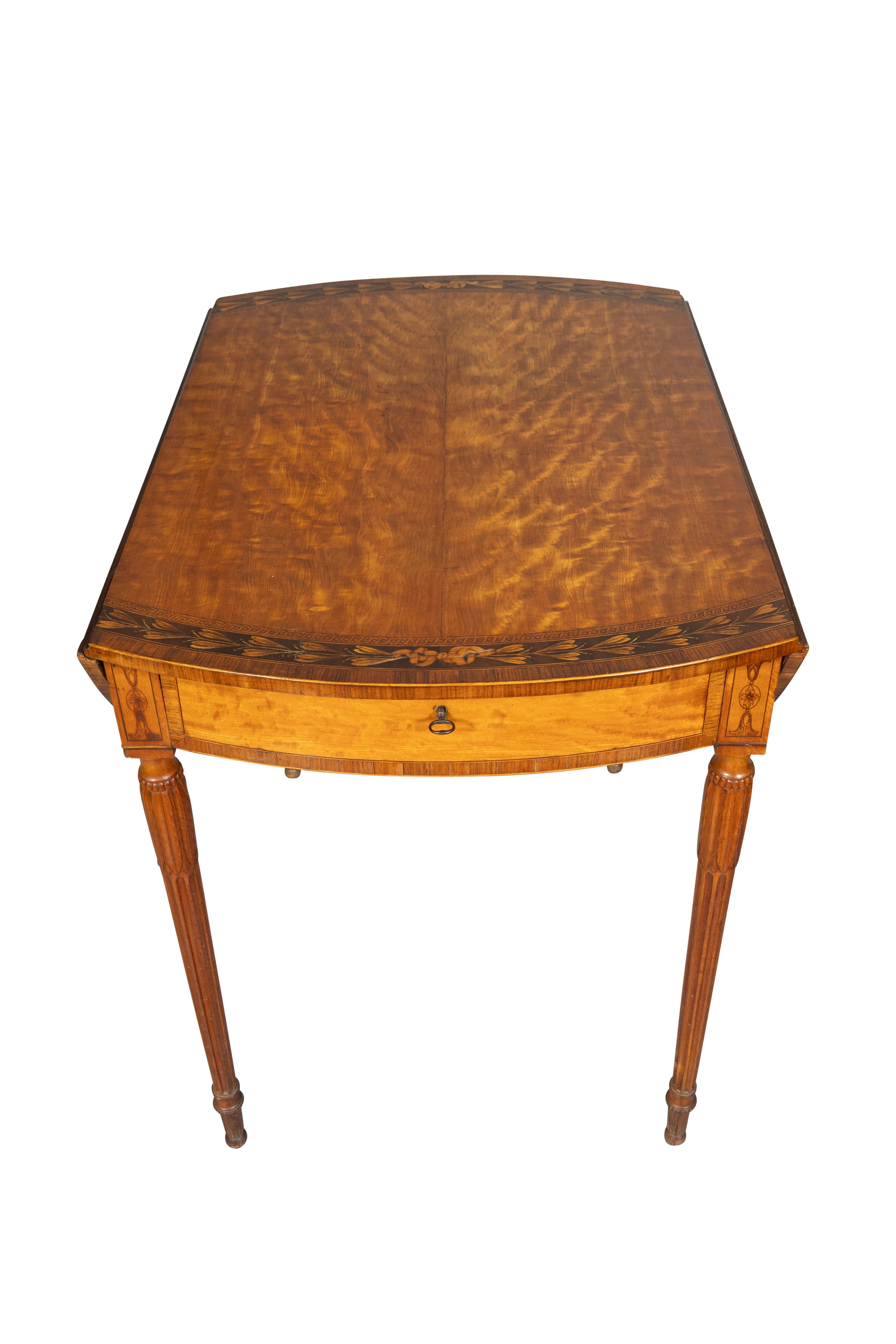 Beautifully figured satinwood with bellflower inlaid border. Bowed frieze drawer and raised on solid finely carved reeded and tapered satinwood legs. 