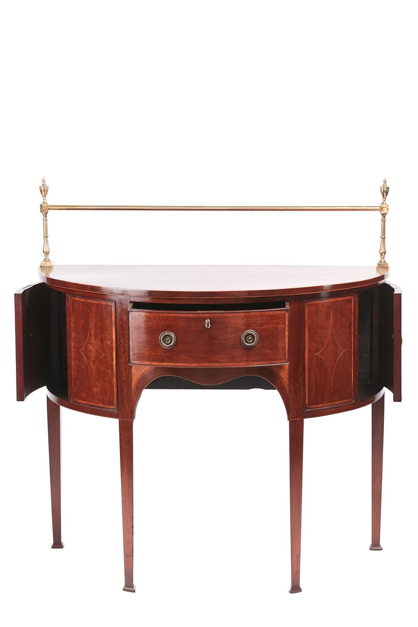 Fine George III small mahogany inlaid demilune sideboard, having a lovely mahogany top inlaid with satinwood and original brass rail, one frieze drawer with original brass handles, two end cupboard doors inlaid with satinwood and original brass
