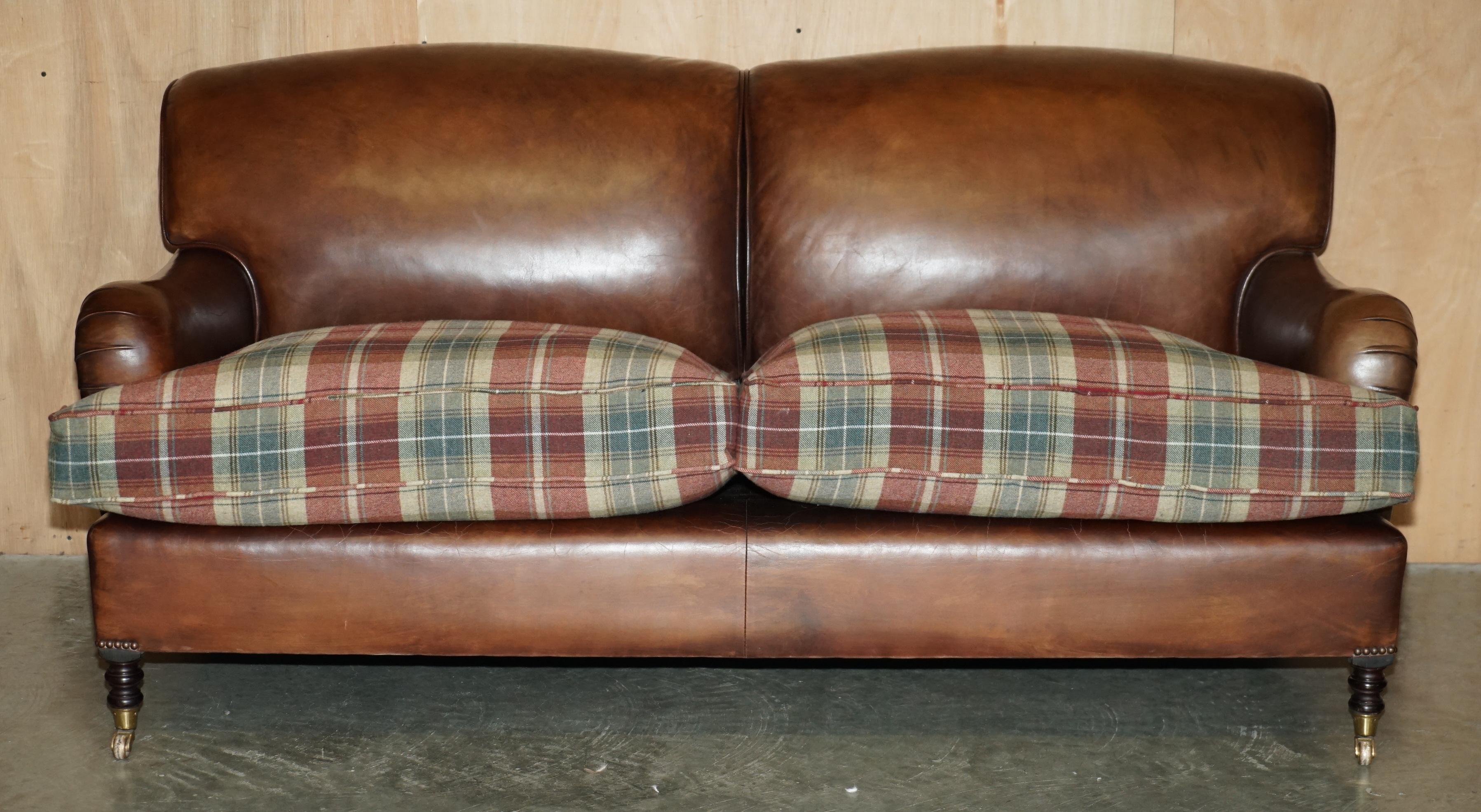 Royal House Antiques

Royal House Antiques is delighted to offer for sale this stunning original George Smith Signature Scroll arm sofa in brown leather with Scottish Tartan wool upholstered overstuff feather filled cushions which is part of a