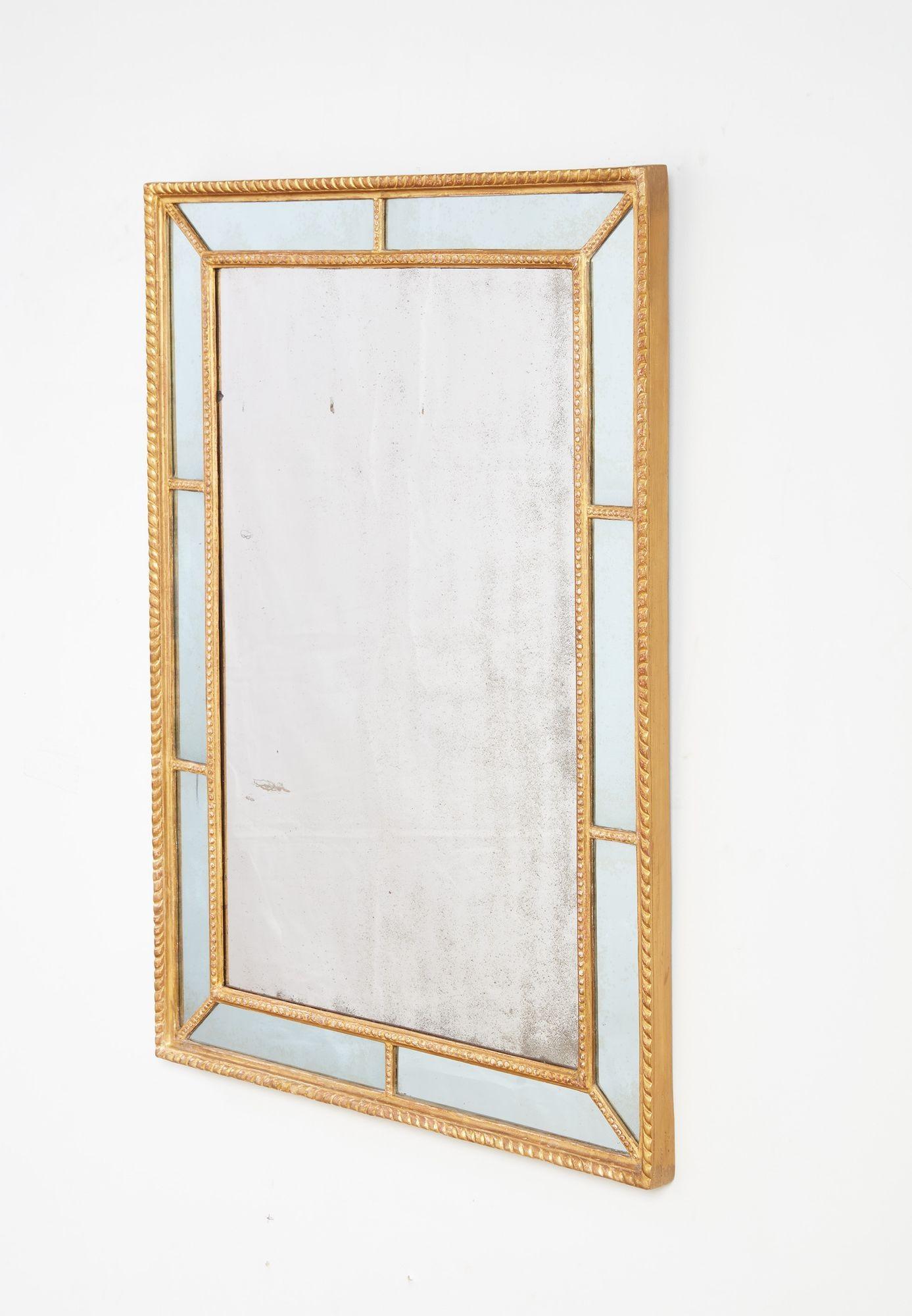Fine George III carved and giltwood rectangular border glass mirror, the frame with gadrooned outer edge and bead carved inner border all in well burnished water gilding, retaining original mercury glass border and center plate, with original