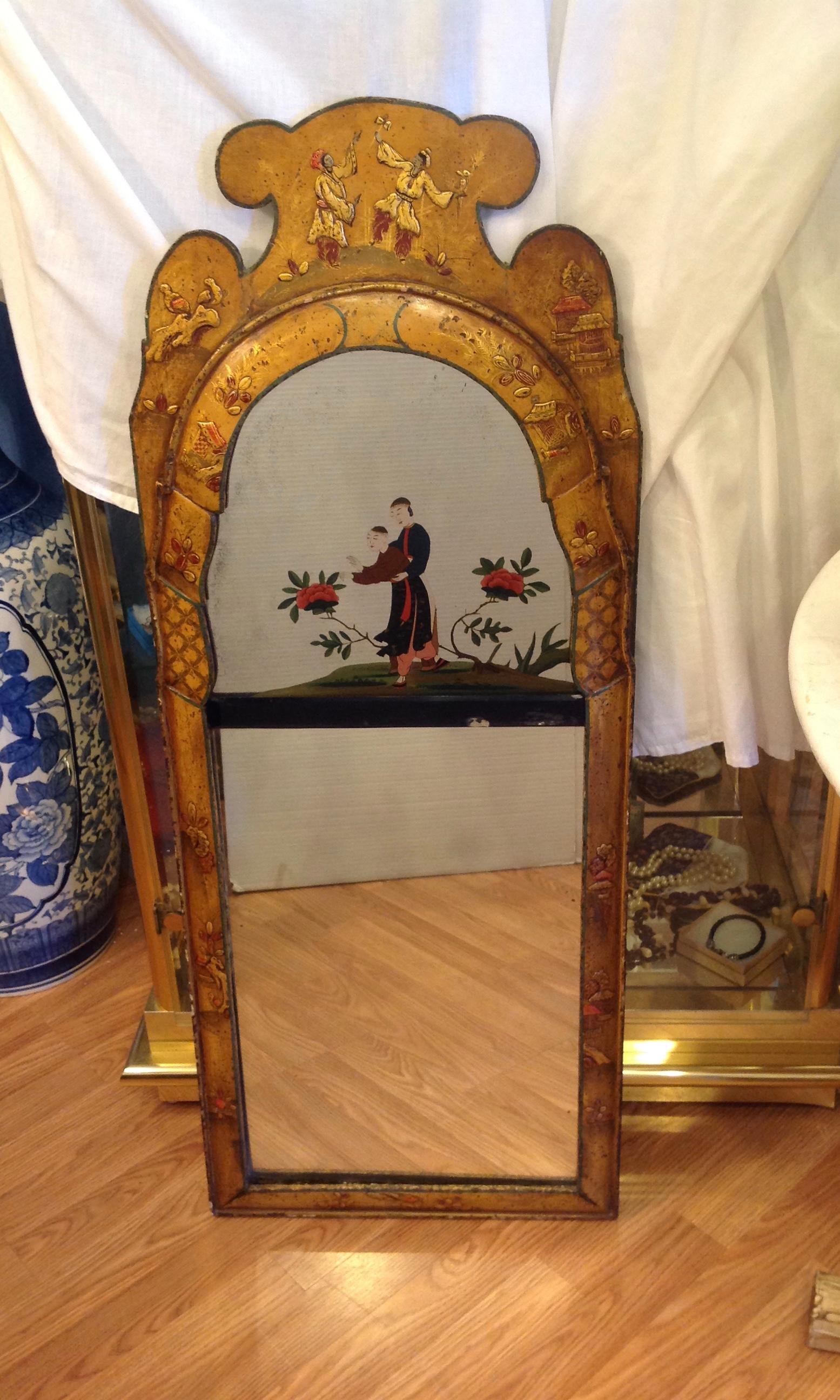 Exquisite detail and quality. Unusual color with an abundance of figures and a 2 part
mirror design. The upper mirror is fashioned with an outstanding reverse painting.
The lower mirror is bevelled.