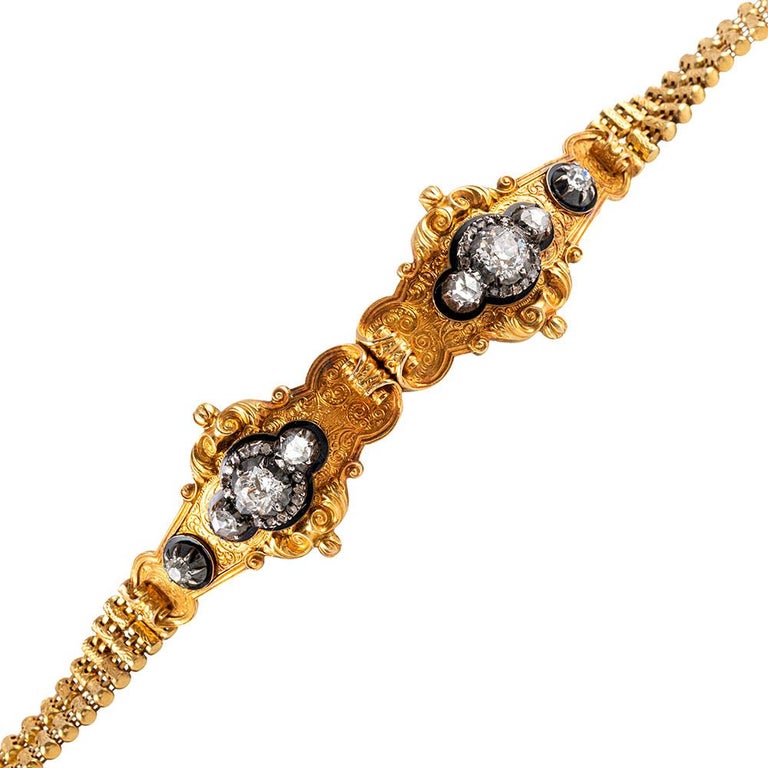 A remarkably preserved and entirely beautiful example of Georgian jewelry, this bracelet is made of 22 karat yellow gold and decorated with old European and rose cut diamonds. The two center stations boast highly detailed, scrolling edges with