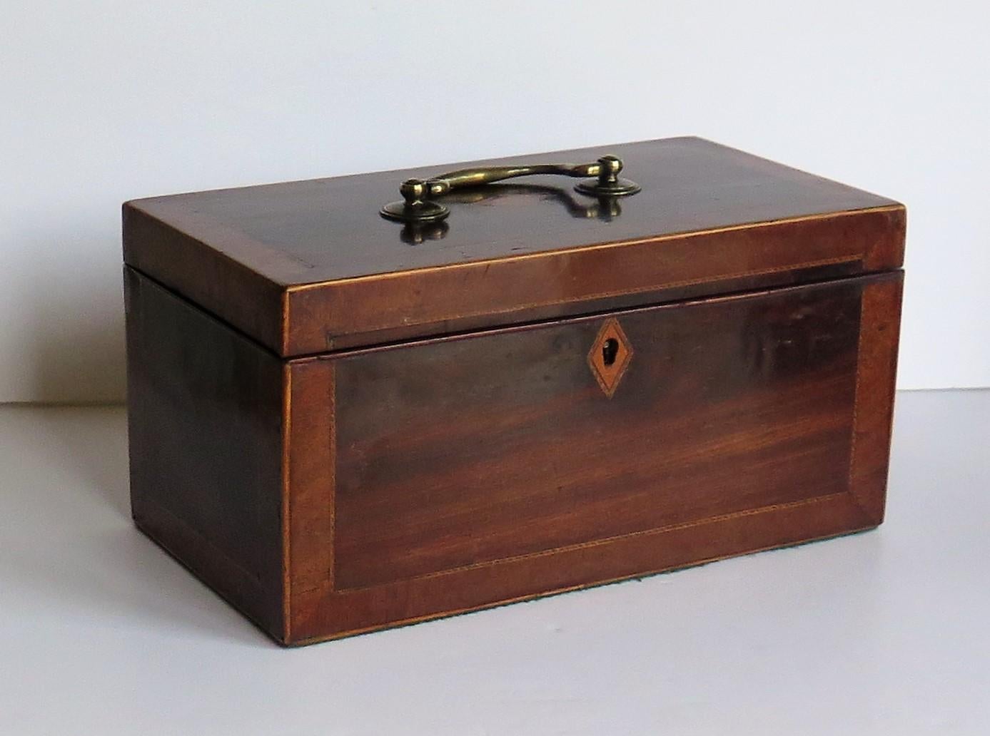 This is a very good quality English Georgian period box or document box with fine inlaid and cross banded detail, having a hinged lid with a brass swan neck handle, dating to the late 18th century, George 3rd period, circa 1780.

The box has a