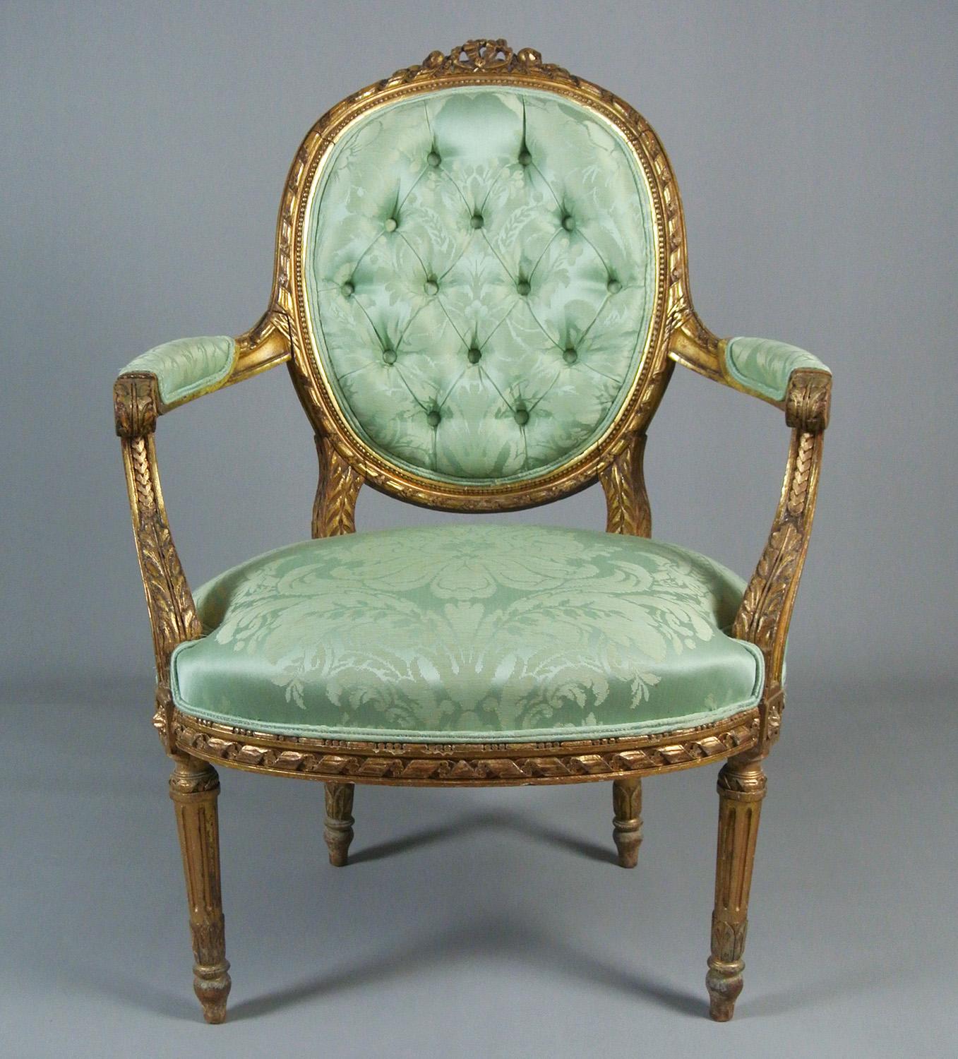Newly upholstered in a spring green pure silk from the Gainsborough Silk Weaving Company (thickly woven from an original 18th century fabric pattern) and with double piped and button back original detailing.

With anthemion and ribbon carving to the