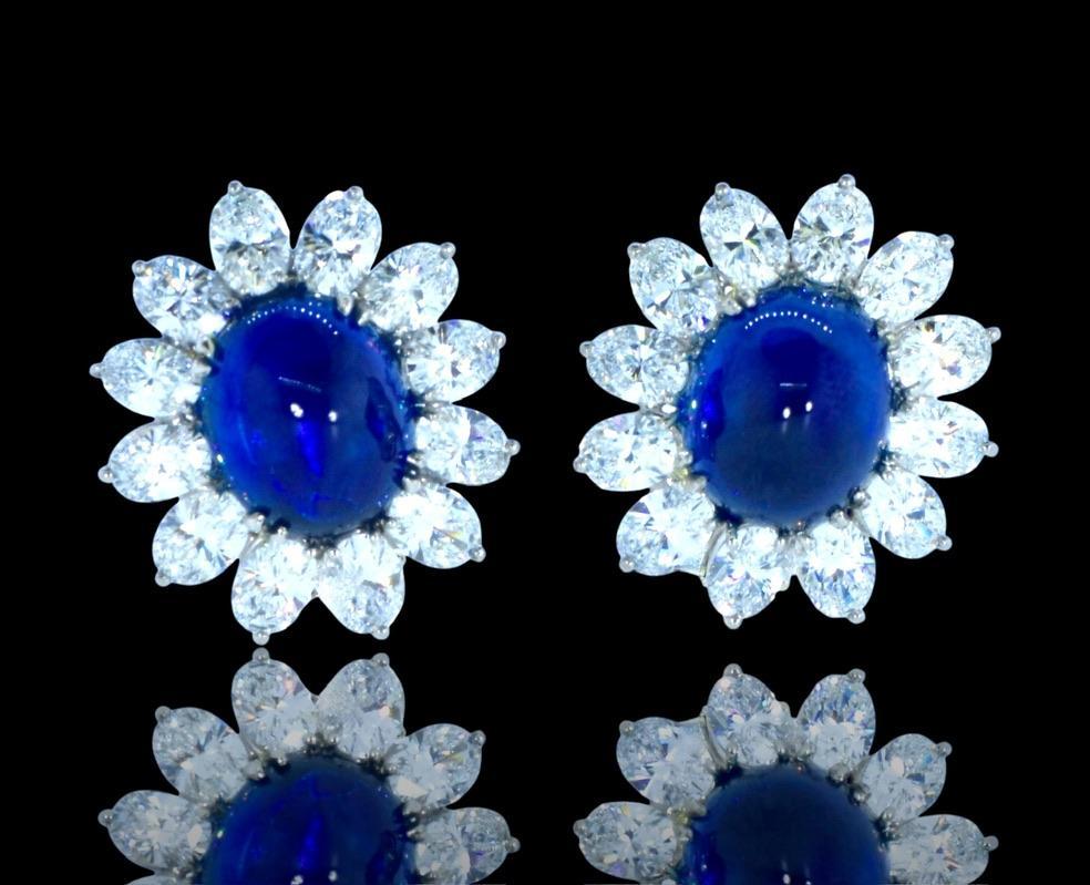 GIA graded natural sapphires, weighing exactly 9.67 cts., and 7.10 cts., are set off by fine white round brilliant cut diamonds. The oval sapphires are a high cabochon cut, well matched, display a rich blue color and are very slightly included.