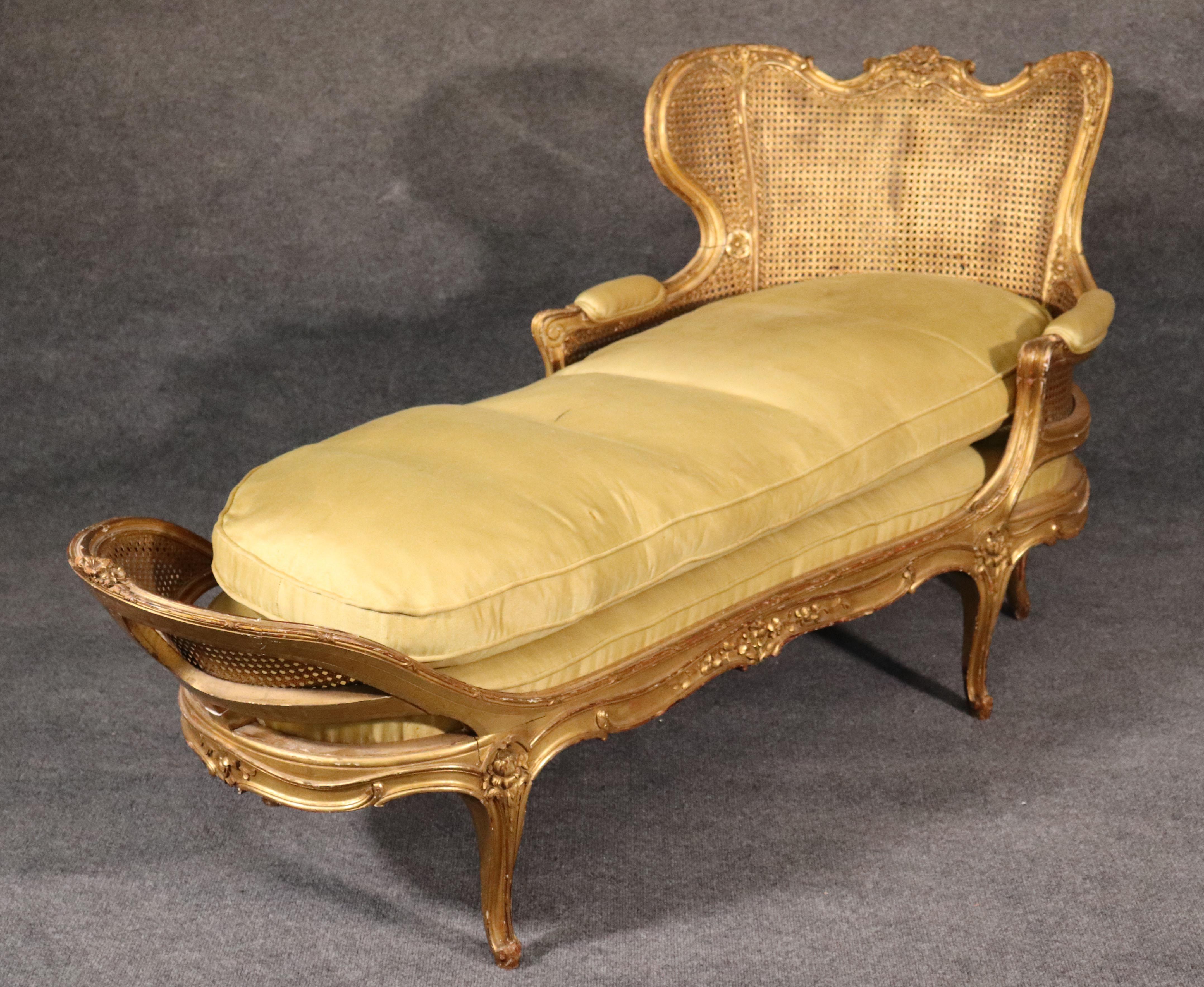 This is truly a work of art and virtually one of the more iconic designs of chaises you're likely to see. The design and detail are superbly executed and the gold leaf is genuine and still retains a fair level of brightness. The upholstery is older