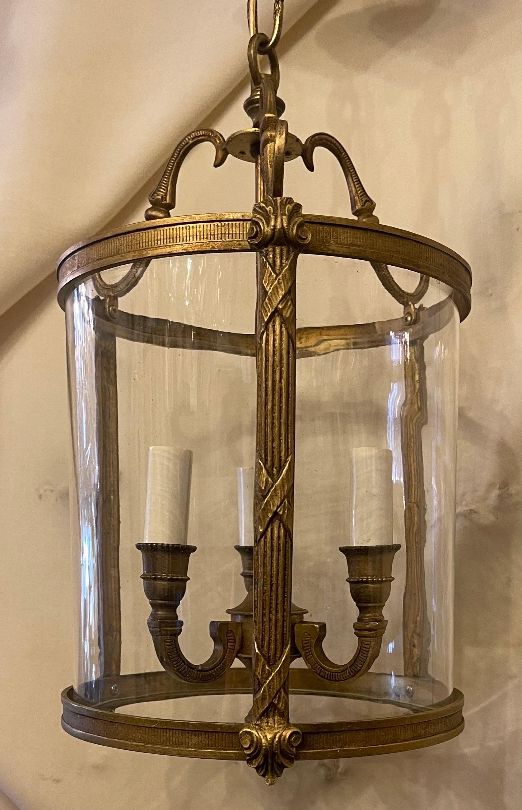 A fine gilt bronze petite readed x-pattern Louis XVI style curved blown glass lantern fixture rewired with 3 new candelabra sockets.