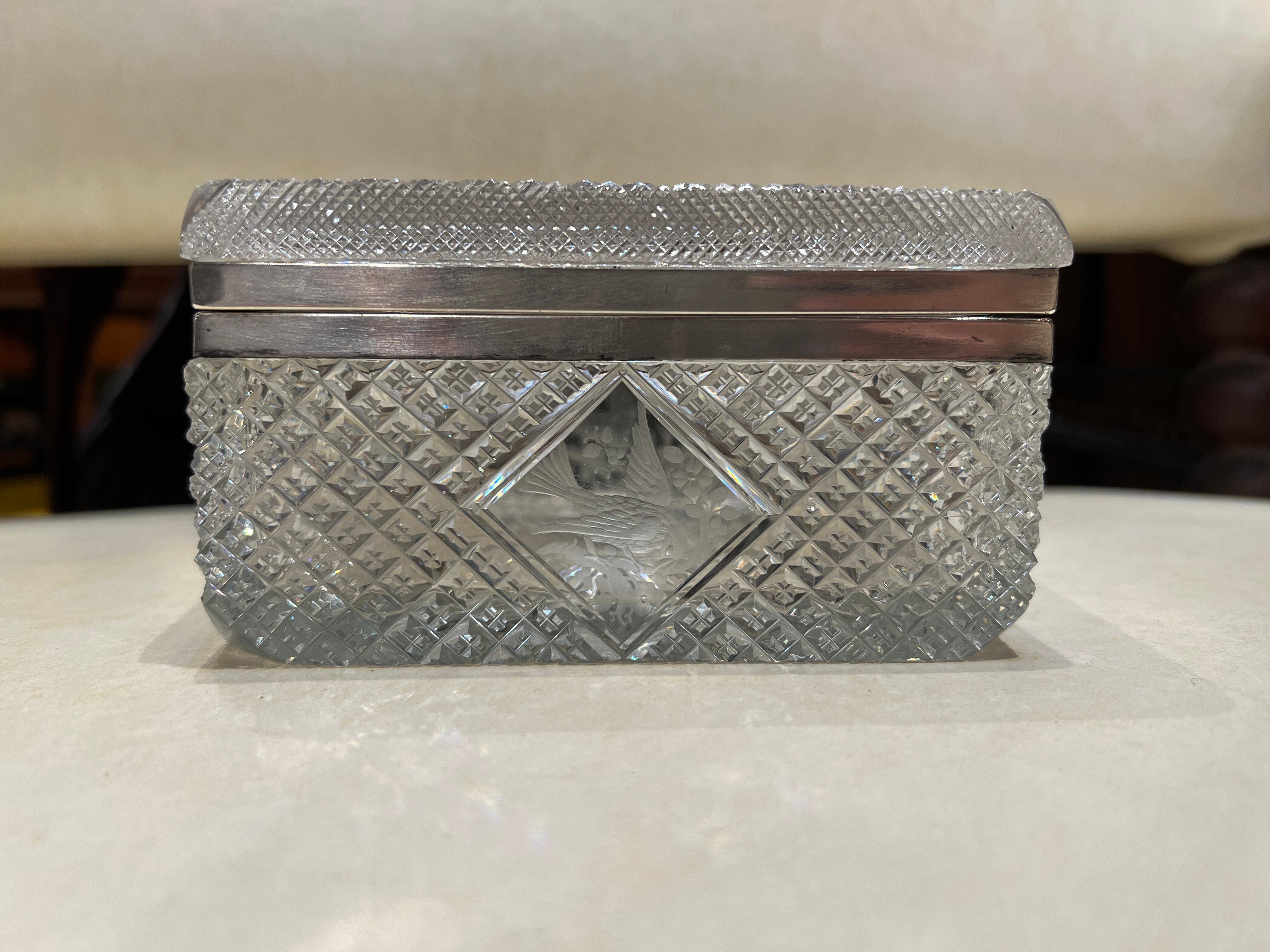 T.G. Hawkes & Co. was founded in 1880 by Thomas Gibbons Hawkes in Tiffin Ohio. 

This exquisite cut crystal and sterling silver box by Hawkes features a beautifully detailed ornithological motif, exemplifying the high-quality craftsmanship for which