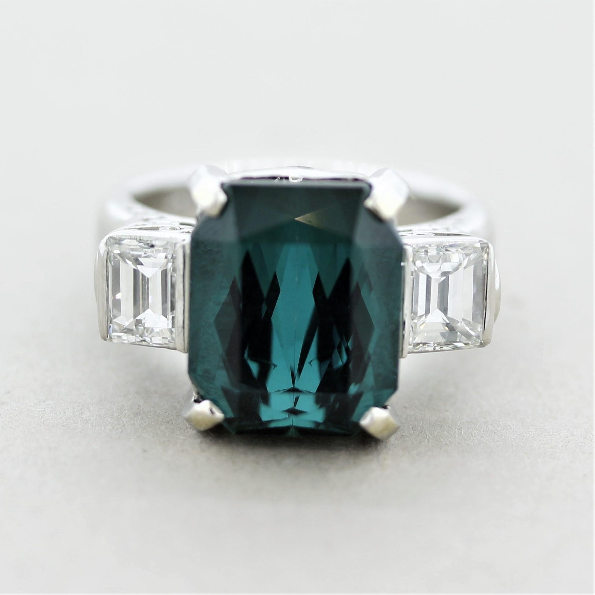 A fine and natural tourmaline with a gemmy greenish-blue color giving it the name “indicolite” in the trade. It weighs 7.31 carats with an intense yet bright vivid greenish-blue color, a true top-quality stone. It is accented by 2 large baguette-cut
