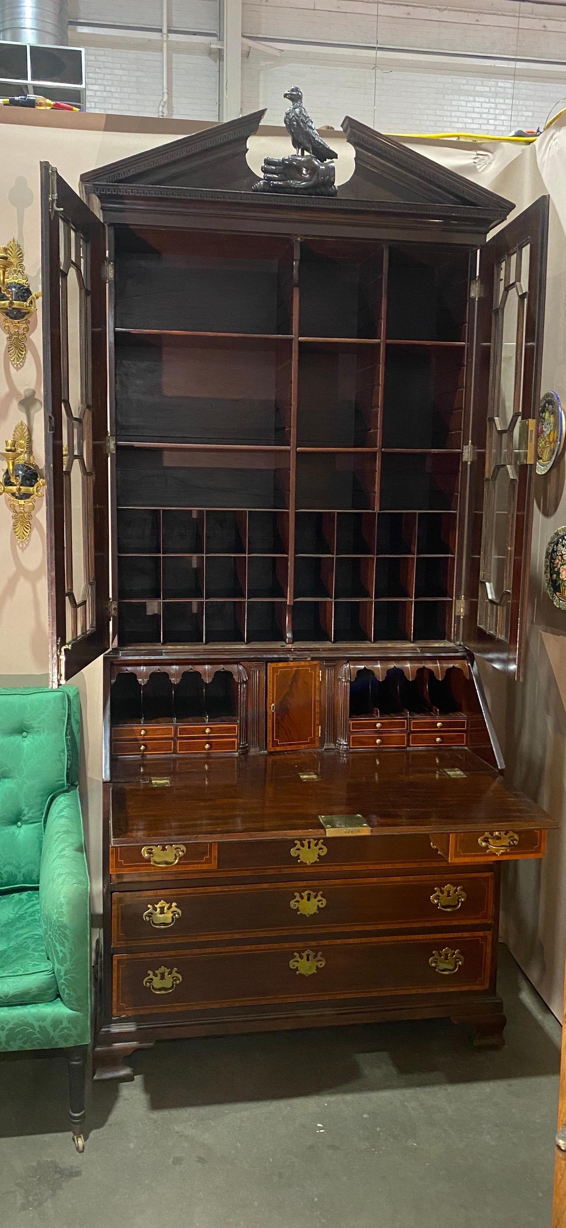 Very good inlaid Georgian secretary with a falconer pediment, probably by Gillows. The secretary features glazed doors surrounded by inlaid stop fluted columns and capitals that are almost identical to examples by Gillows. The fall front opens to