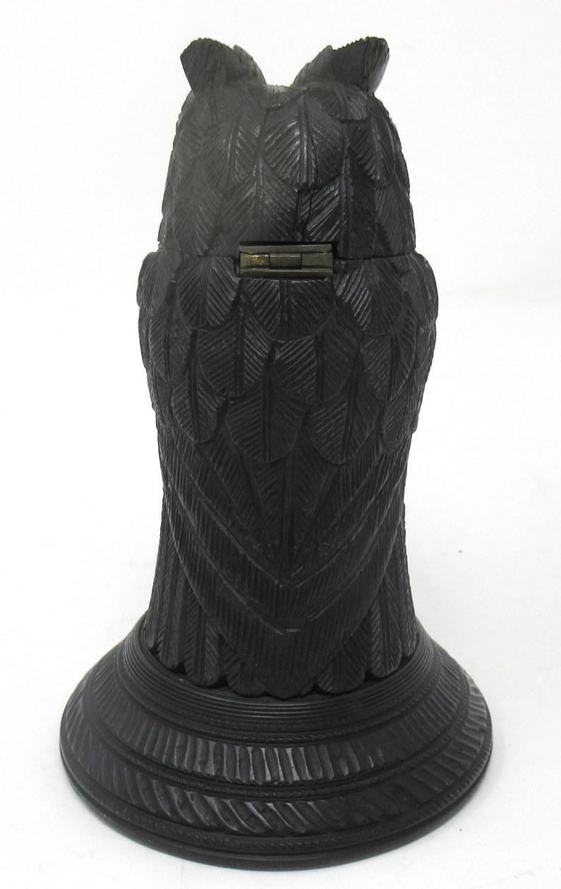 Exceptionally fine and rare hand carved Irish bog oak figural owl of museum quality and medium proportions, quite possibly by Cornelius Goggin. Made during the mid-19th century. 

The hinged head is complete with its original brown and black glass