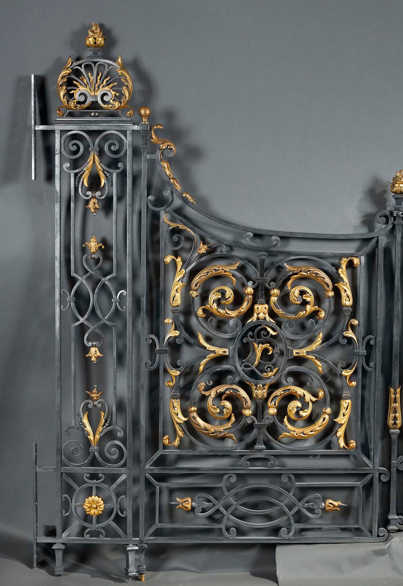 Made in wrought-iron, interior gate composed of two gate-sides and two doors, with an elegant decor made of scrolls, enriched with gilt bronze ornaments.
The gates are probably made after a design of Gabriel Davioud (1823-1881) 
Provenance