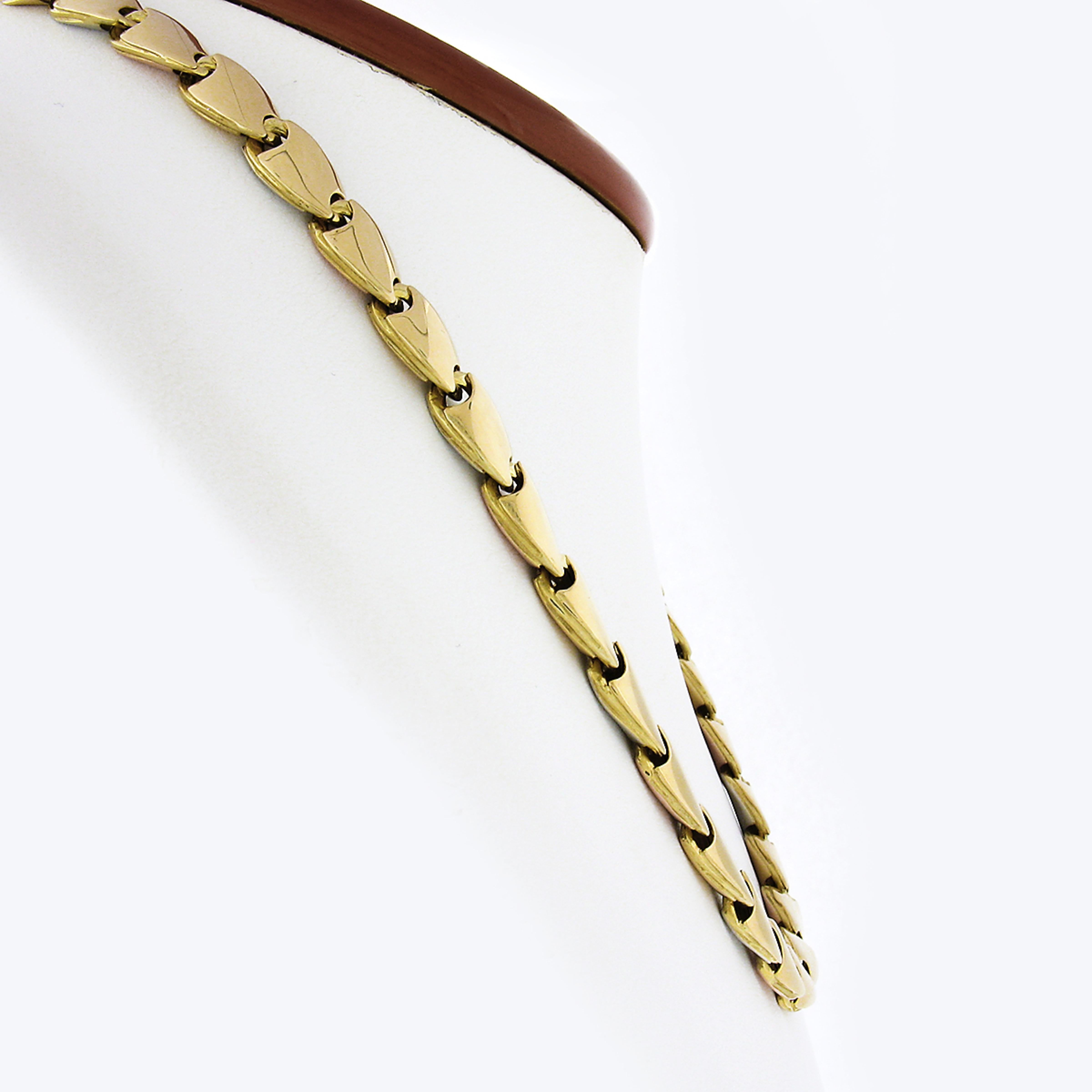 This gorgeous necklace was crafted in Italy from solid 18k yellow, white, and rose gold. It is reversible in design and feature two different patterns. On one side the links are all yellow gold and on the other side the links cycle through a pattern