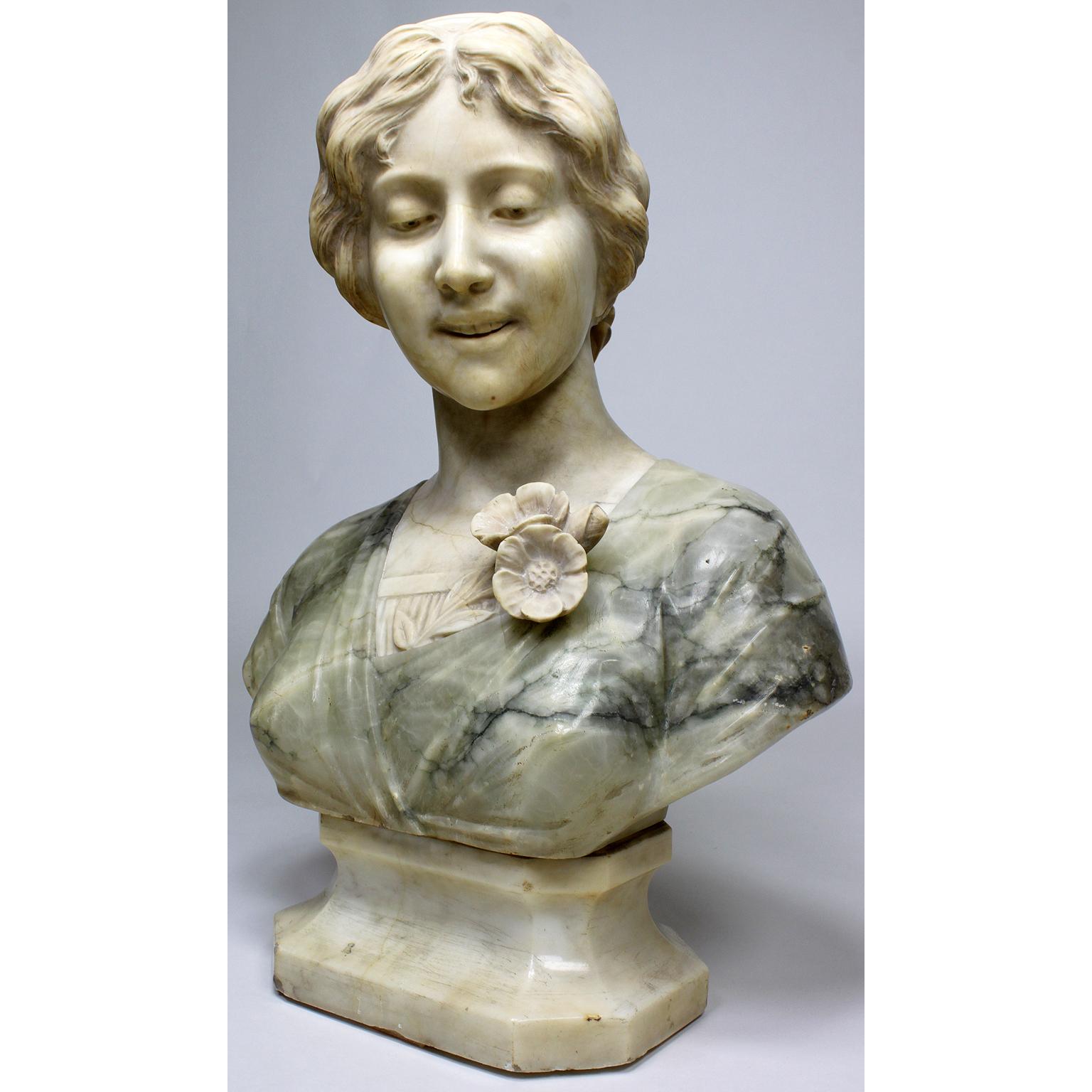 An Italian 19th-20th century carved color-alabaster bust of a young beauty. The finely carved two-tone alabaster bust, depicting a young girl posing with a side gaze and wavy hair tied with a headscarf, her blouse is depicted in an