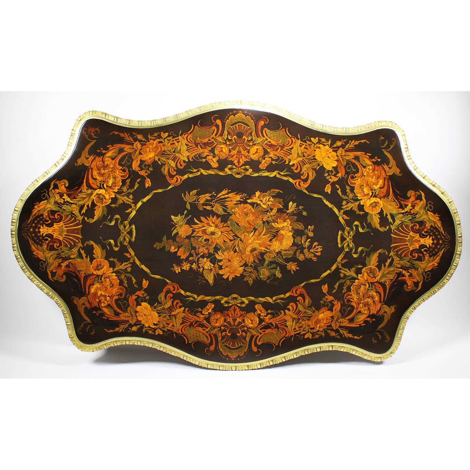 A very fine Italian 19th century mahogany, satinwood and tulipwood floral marquetry and gilt bronze-mounted centre table. The ornately decorated marquetry top centred with a floral bouquet design within a banded ribbon medallion, flanked all around