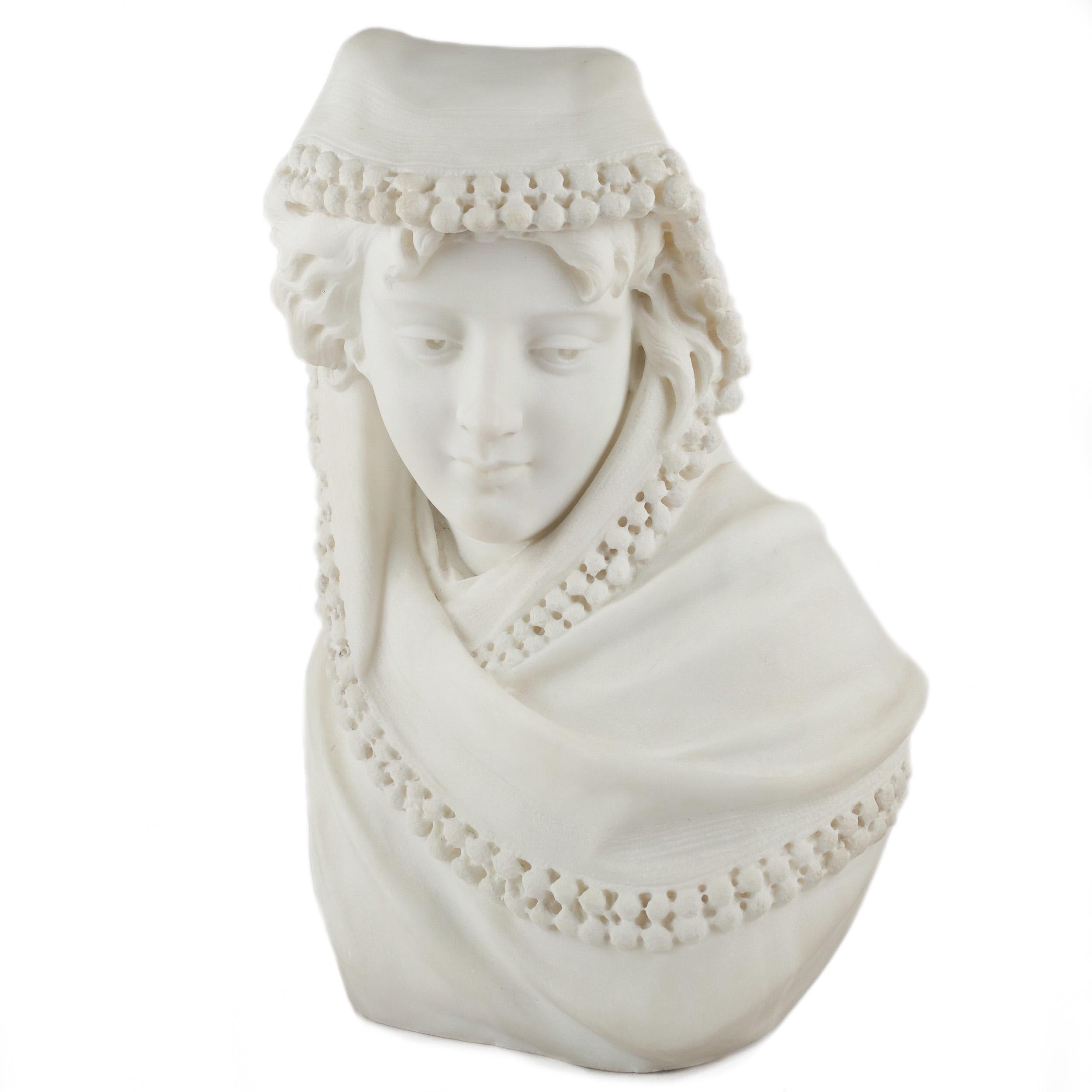 An exquisite late 19th century bust of a Provincial young woman carved from a single block of Carrara marble, the ability of the unknown sculptor to capture movement and spirit is notable. Her feminine features are soft and confident, totally at