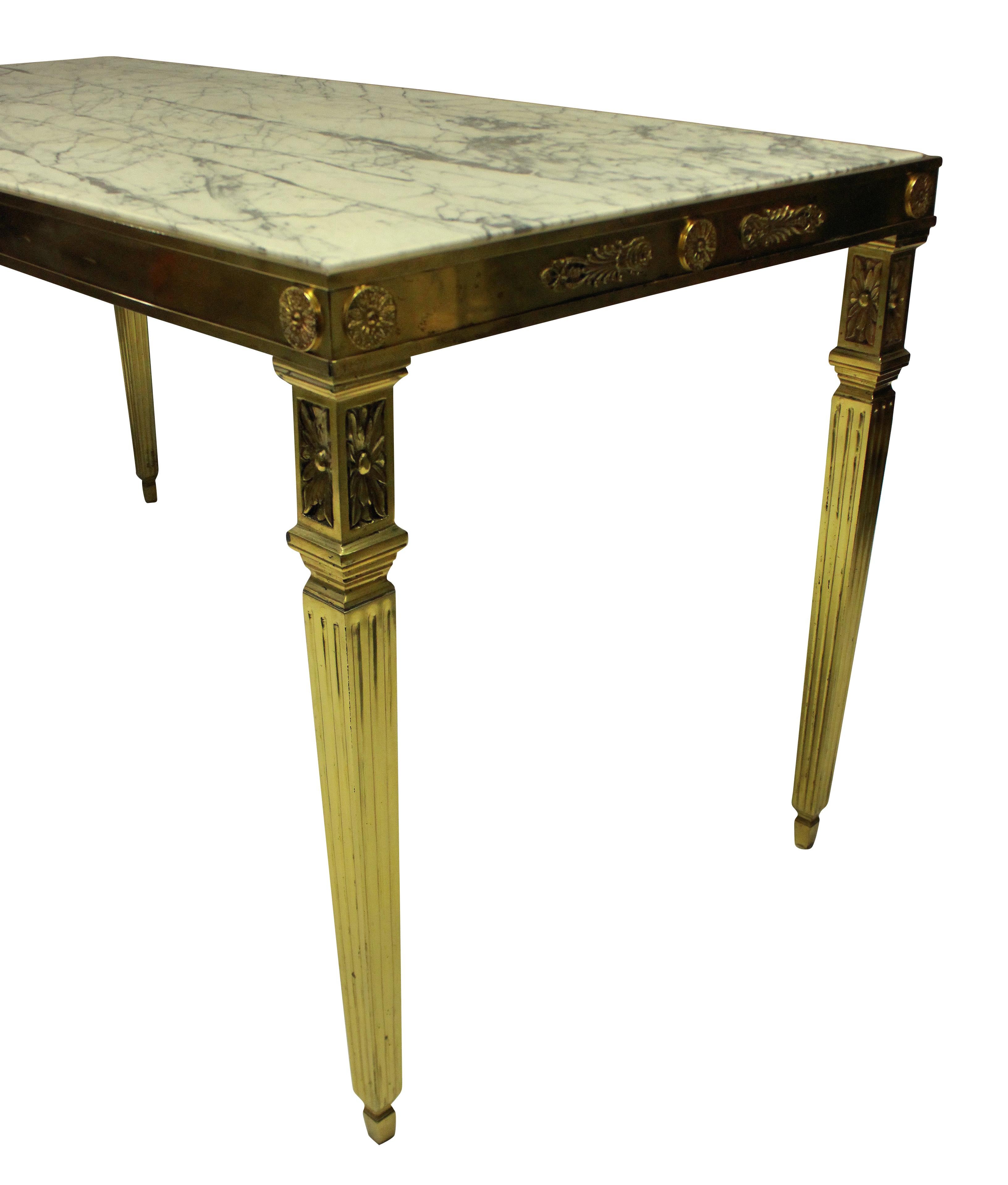A fine Italian gilt bronze neoclassical center table, with acanthus decoration around each frieze and on square tapering fluted legs. With an inset grey and off white marble top.