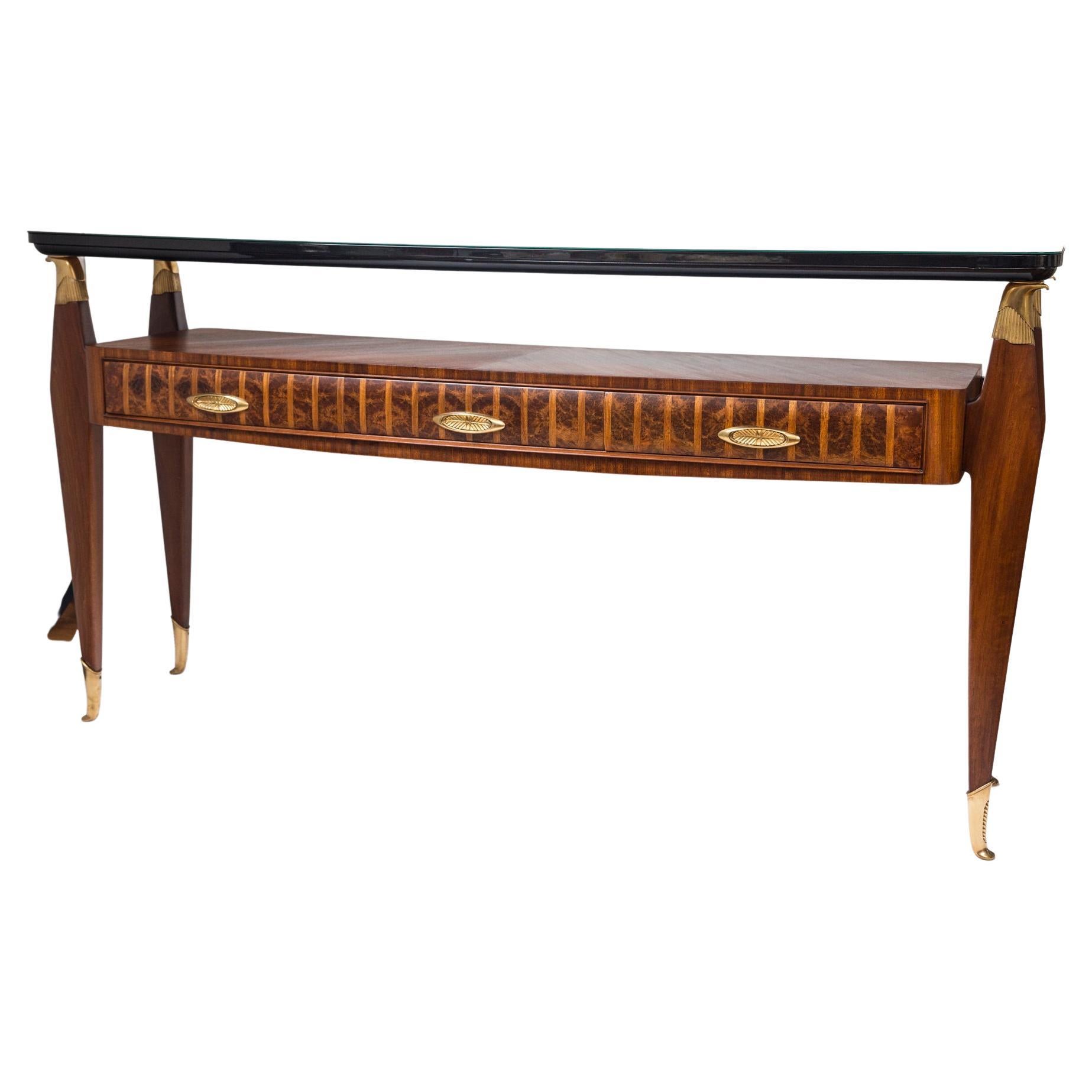 A superb two-tiered console/sideboard with beveled black floating glass plateau supported by bronze eagle heads above an elegant rosewood base comprised of three drawers adorned with oval shaped bronze pulls.

Note finish is not high gloss,  instead
