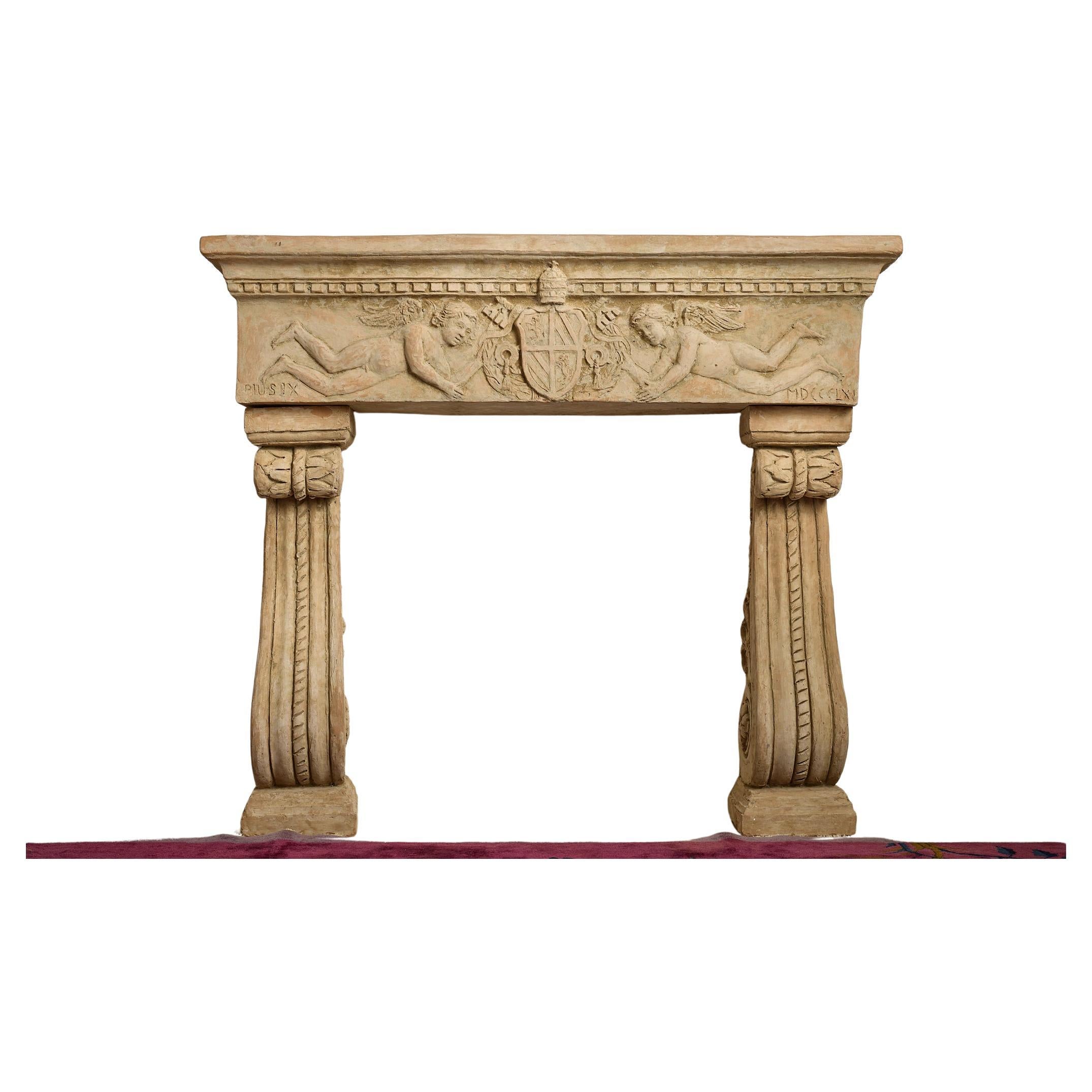 Fabulous terracotta mantel piece or fire surround, inscribed PIUS IX on the left hand side and MDCCLX (1760) on the right. The top section of the mantelpiece carved with two angels holding the papal crest of Pius IX, surmounted by dentil