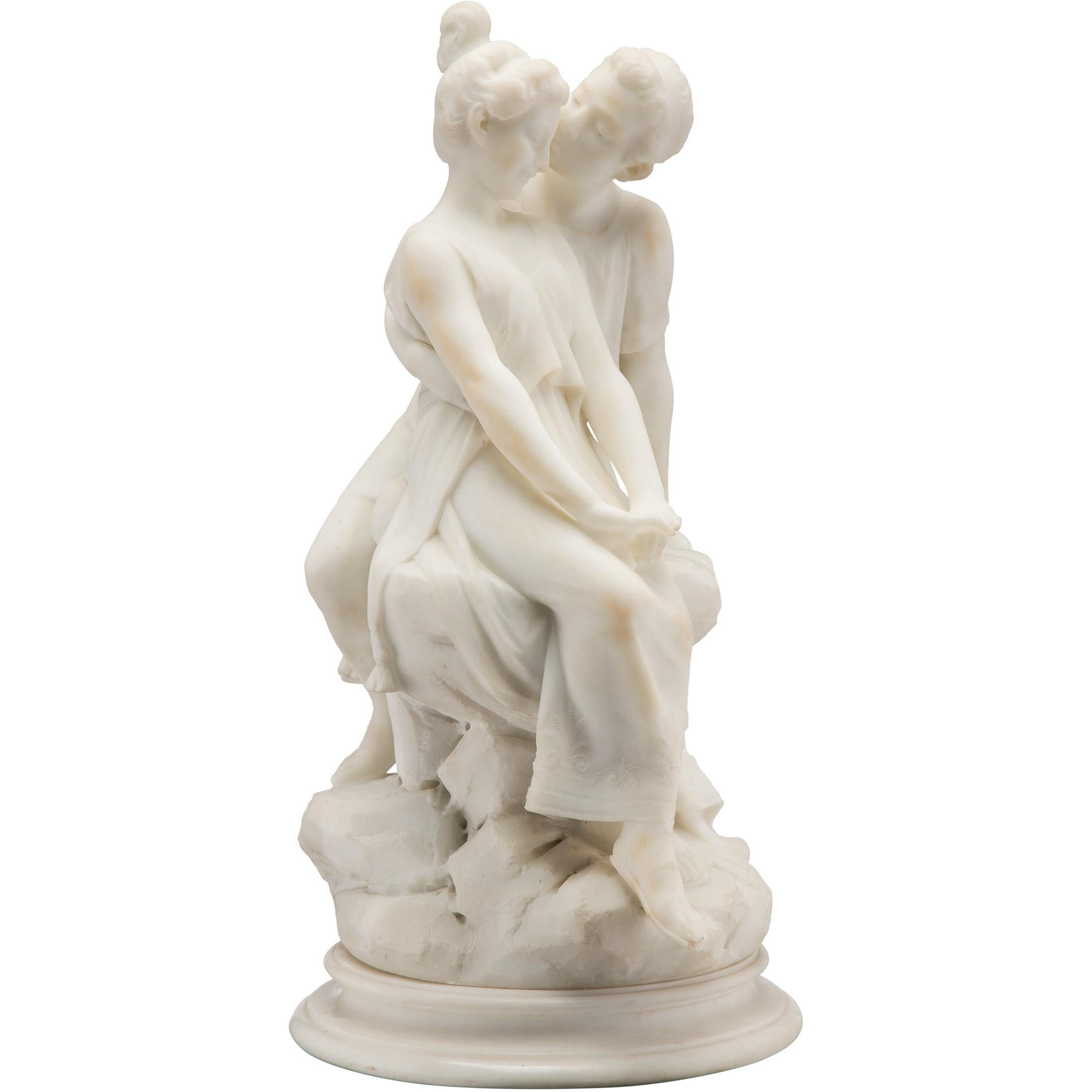 Die fein gegossene italienische Skulptur eines Liebespaares aus weißem Marmor steht auf einem runden Marmorsockel, der mit 