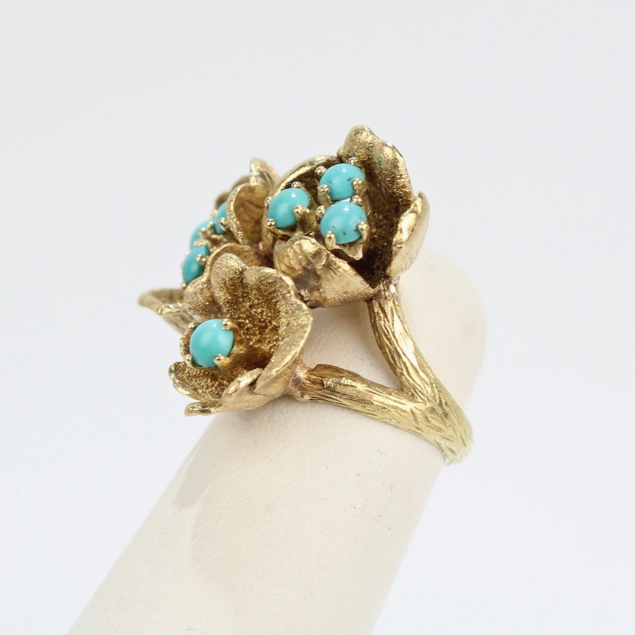 A fine J. Rossi 18K gold and turquoise ring with delicate gold flower blossoms.

The ring has textured gold that forms figural leaves, petals surrounding turquoise beads, and a 'twig' shank. 

The posts holding the beads move just a little and allow