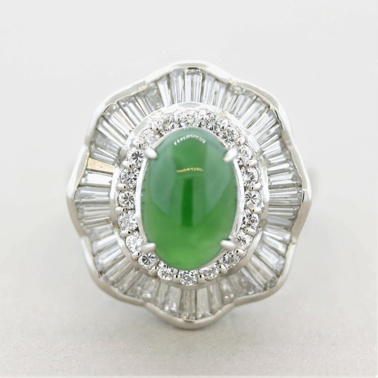 A stunning top-quality gem certified by the GIA as natural and untreated. The jadeite jade weighs 2.82 carats and has the ideal vivid grass green color that is even and semi-translucent. The stone appears to glow in the light! It is accented by 1.80