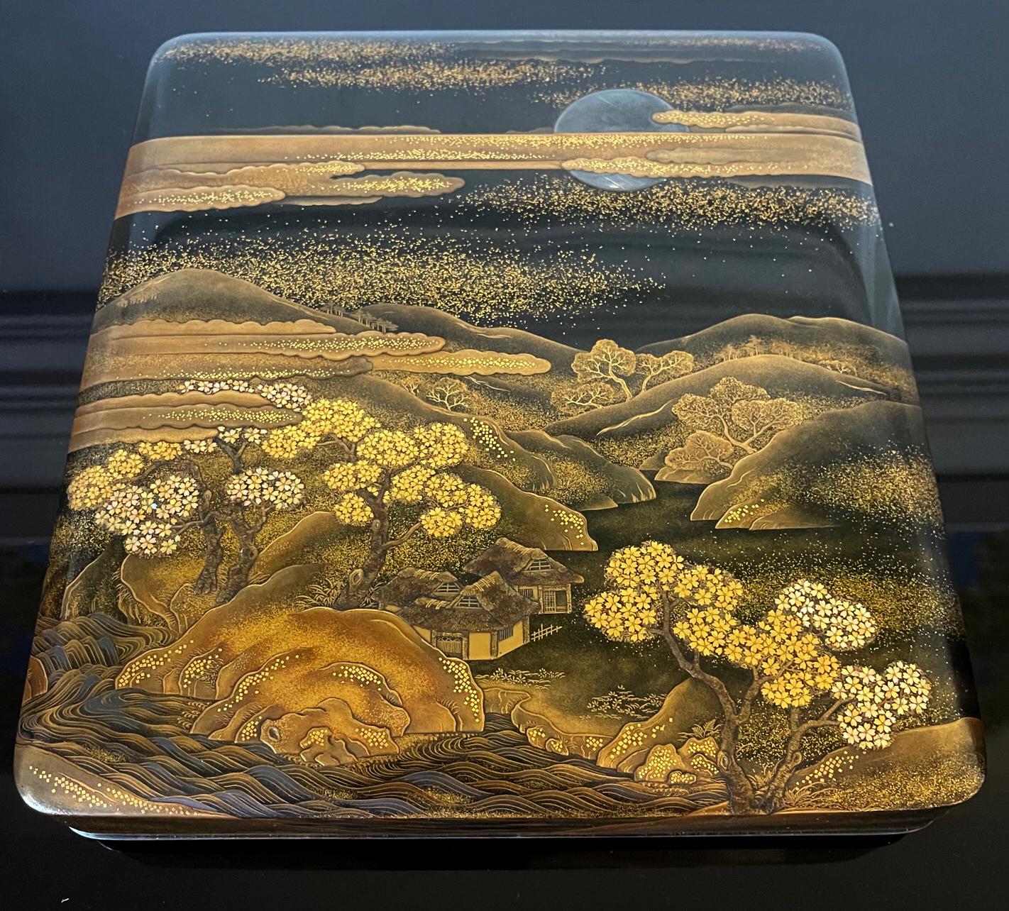 A very fine Japanese Maki-e Suzuribako (inkstone box) with a complete set of seven writing implement circa early to mid-19th century (late Edo period). The dark roiro color case showcases an ambient nocturnal landscape in and around Mount Fuji.