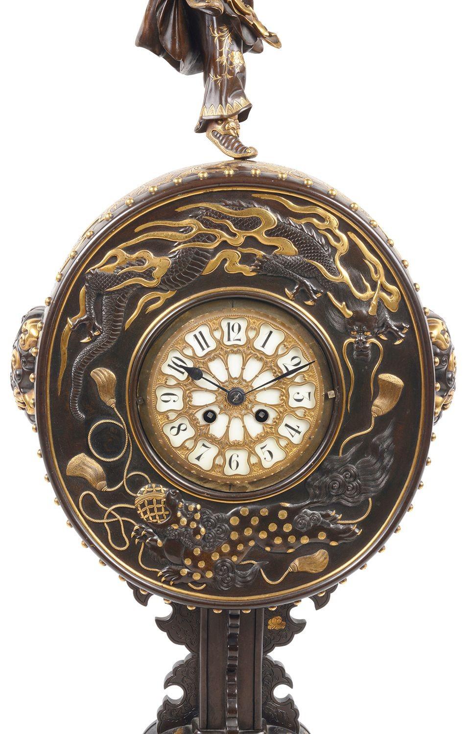 A fine quality and rare, Japanese Meiji period (1868-1912) Signed Miyao bronze mantel clock. Having a charming drummer boy above a drum like surround to the clock, with scrolling foliate gilded decoration, mythical dragons and faux dogs. Raised on a