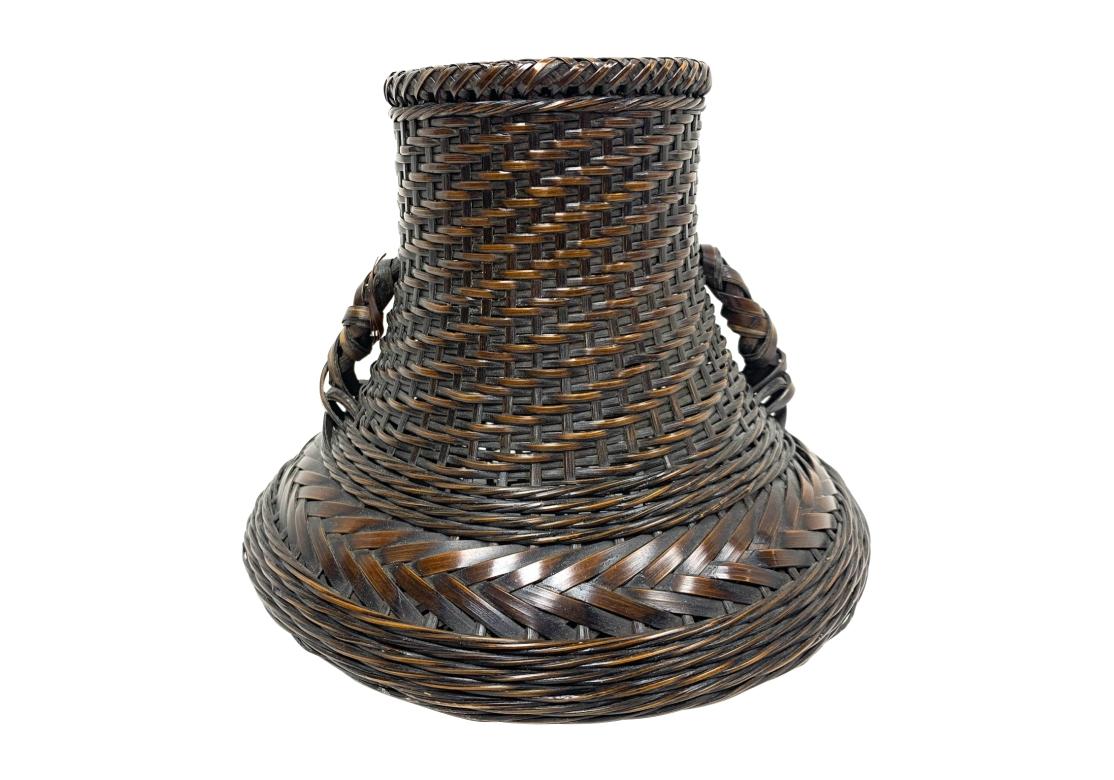 An intricate and finely woven Mid Century Japanese Handled Ikebana Basket. The Basket with very finely woven 
strands incorporates various different weaves in its construction. Having an unusual form, the Basket has handles, draining screen at the