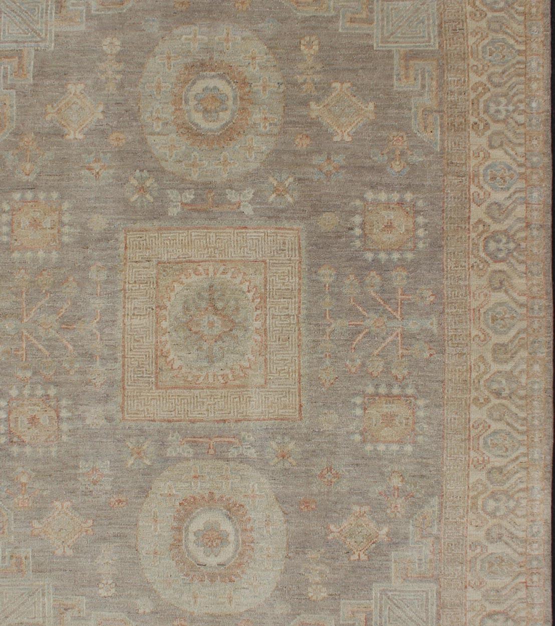 Light color Khotan rug with geometric Medallions in gray, tan, pale green, rust and light blue, rug/MP-1903-10518 country of origin / type: Afghanistan / Khotan

This Khotan features a traditional Samarkand design with circular and square