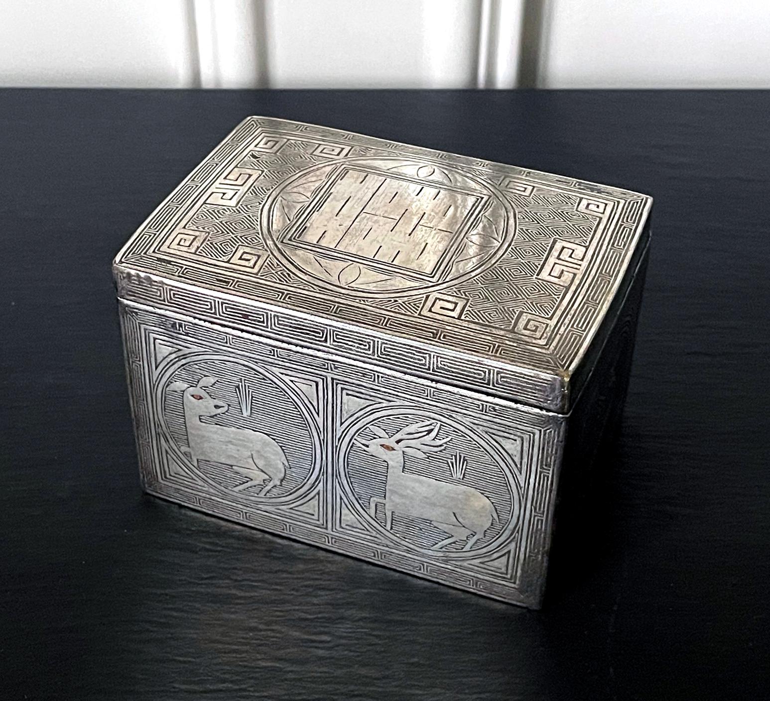 A fine Korean iron box used to store tobacco leaves dated to the late Joseon Dynasty circa 19th century. The box is made from iron and has a heavy weight, although the wears along the edges of the lid and base exposes a bronze metal color