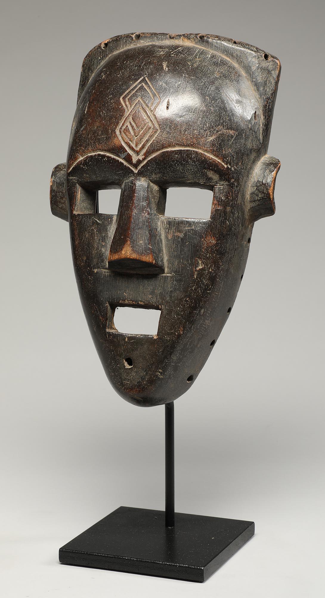 Fine and well carved wood Kuba Kete face mask with striking open square eyes and mouth, incised scarification mark on forehead, interesting backwards facing ears. From Democratic Republic of Congo, early 20th century. Ex private collection WA, ex