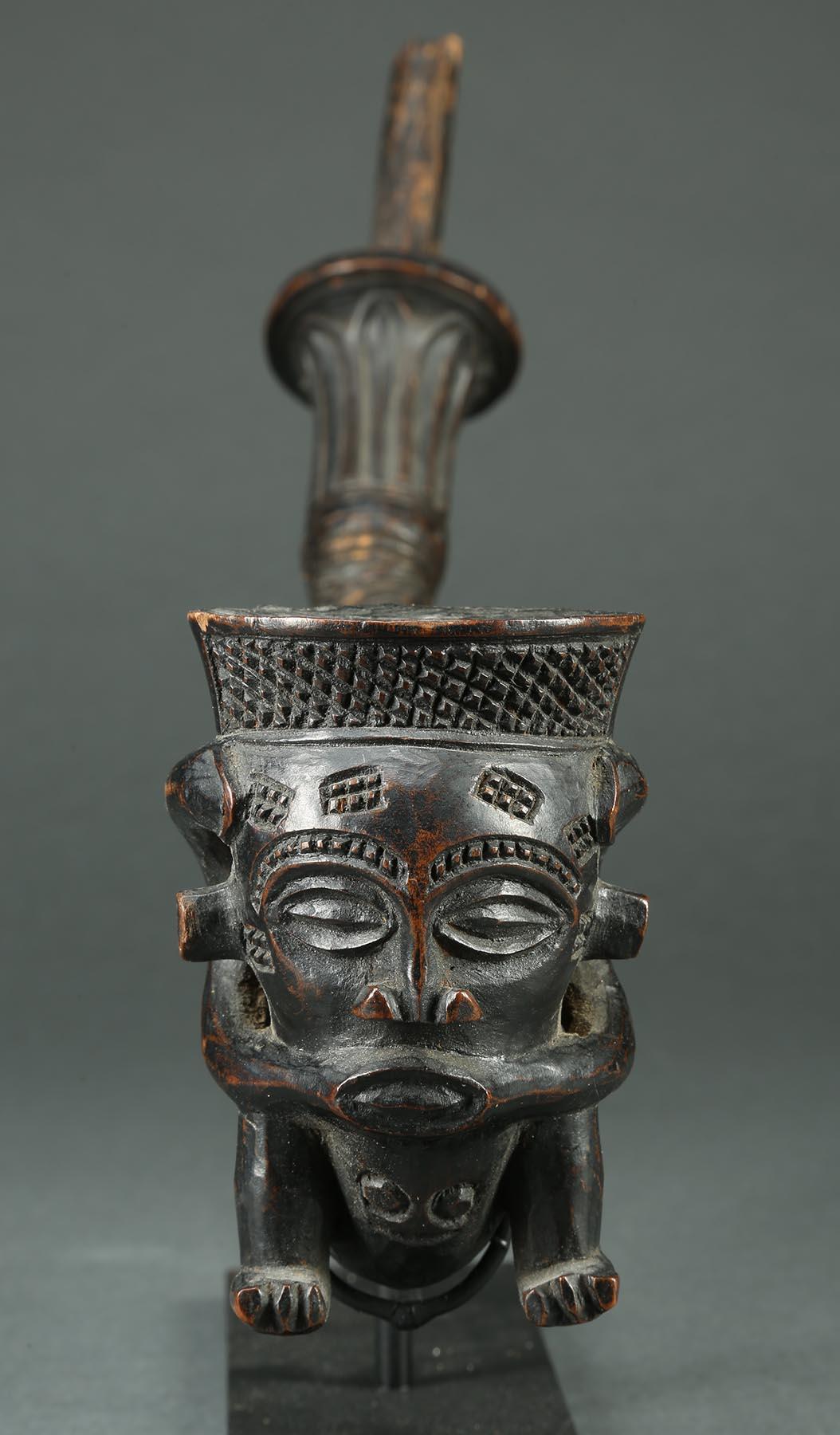 Fine Kuba Wood Figural Tribal African Pipe, early 20th century 

Kuba pipe with squatting figure on front, expressive face, geometric raised connected part with classic Kuba style design.  Abstract antelope mask on the stem.  In three parts, with