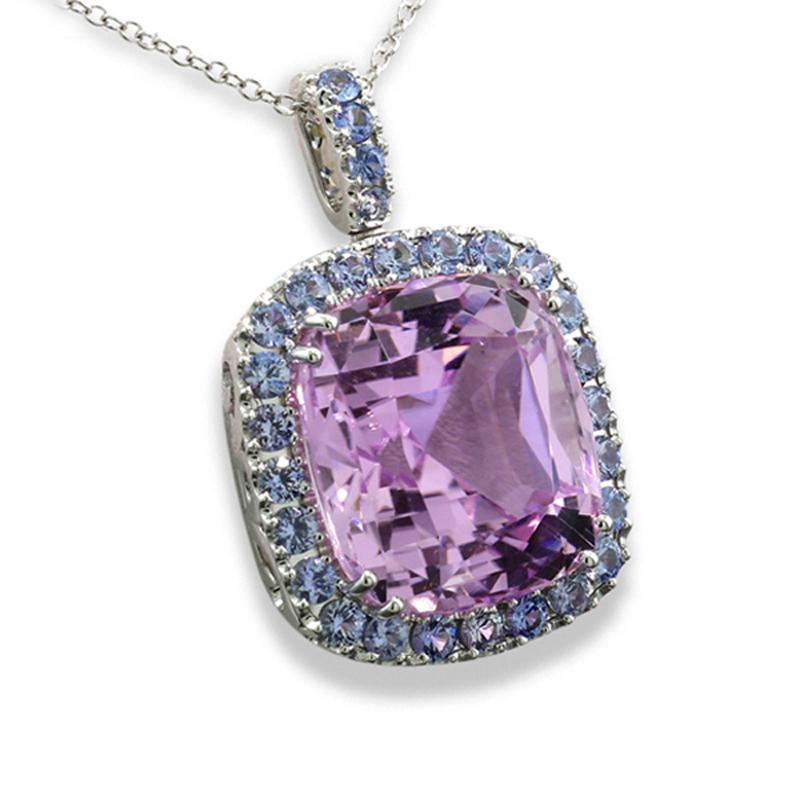 pendant with a kunzite approx. 23.31 carat, rectangular cushion (mixed cut), bright rose, eye-clean with uniform color distribution and in eye-clean quality.  Frame and face of the bezel are set with numerous round cut sapphires totaling approx.
